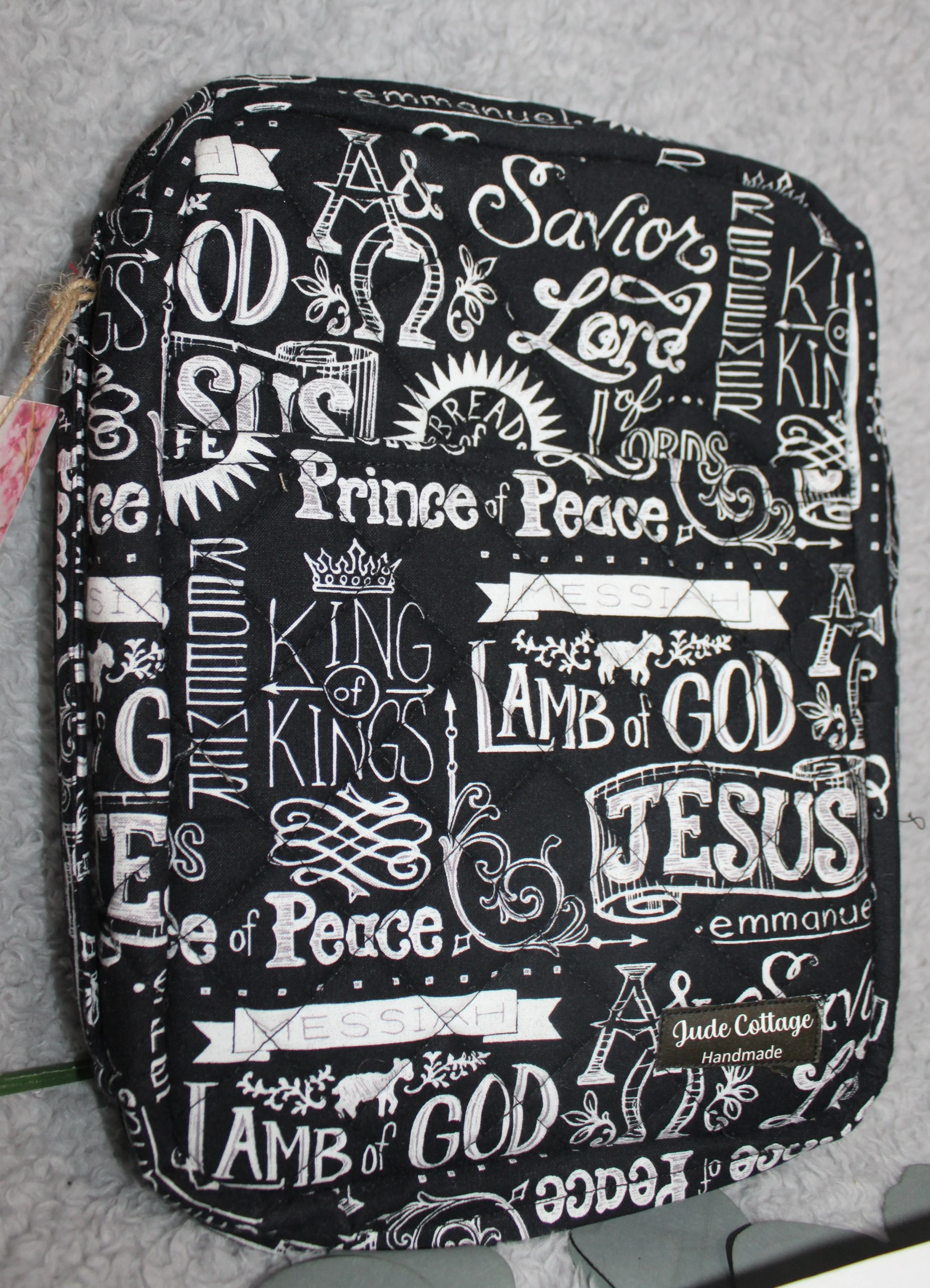 Side view of the black and white ‘King of Kings’ Bible case with inspirational religious wording, showing the sturdy padded handle.