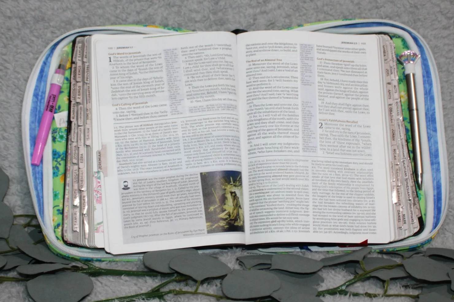 Interior view of the Suzanne Study Bible Case with a Bible inserted, showing the floral lining, interior slip pockets, and pen holders.