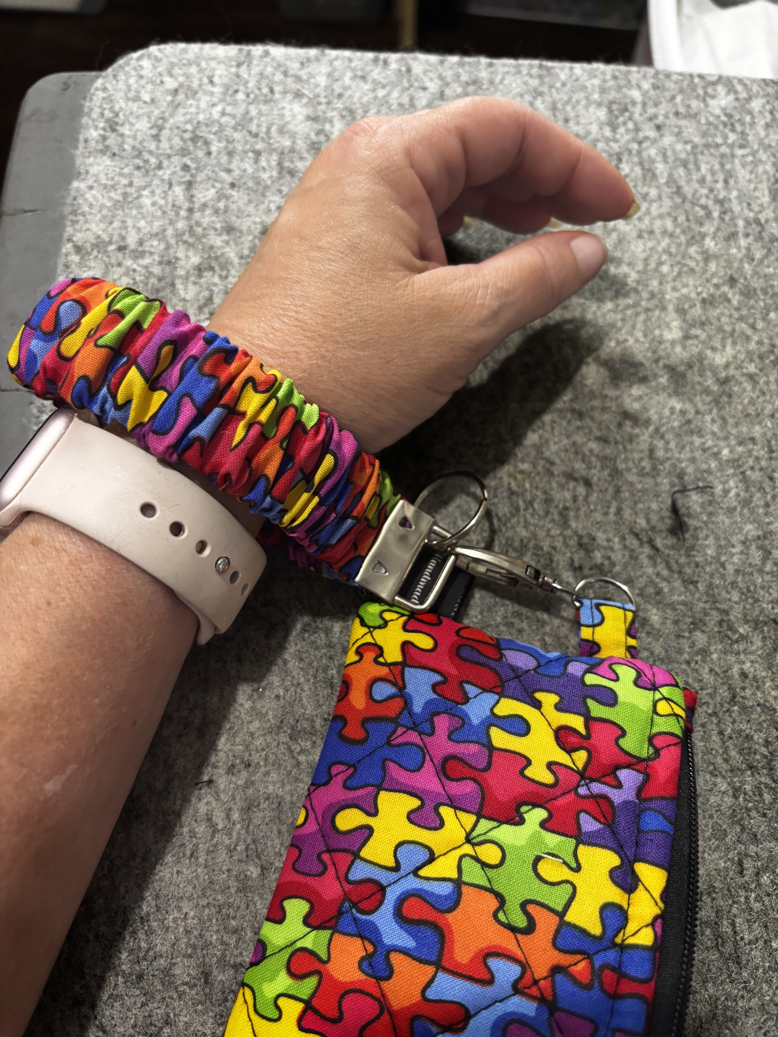 Autism Awareness Wallet Set shown worn on a wrist to illustrate use.