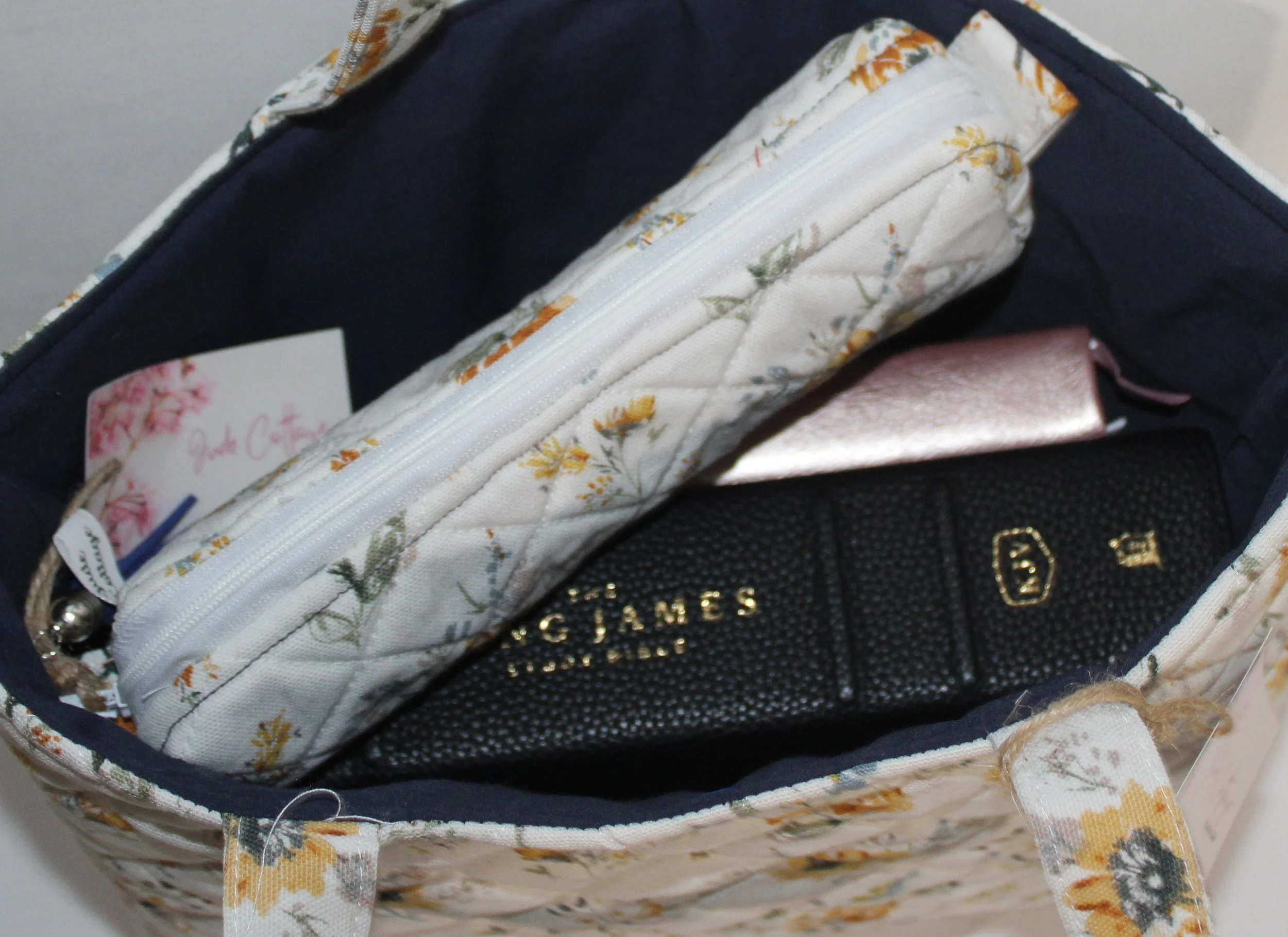 Top view of Dandelion Blue shown with a study Bible, notebook, and pencil pouch inserted to illustrate size and use.