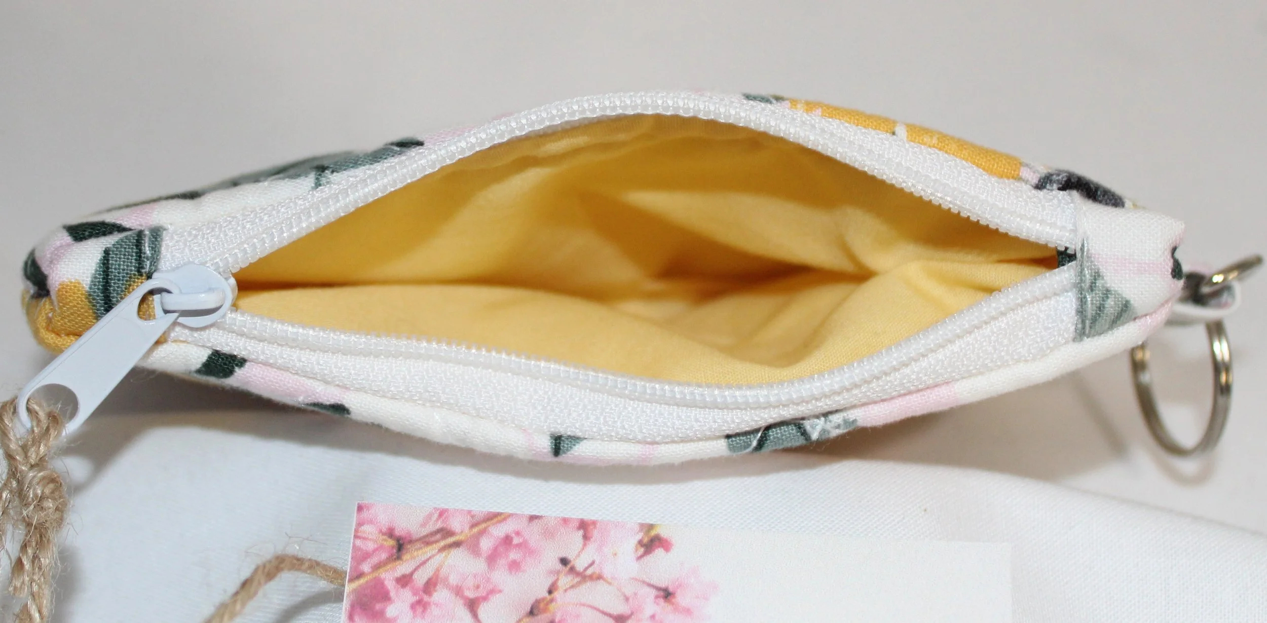 Top view of Honeycomb Sunflower quilted floral wallet showing the zipper and yellow interior.