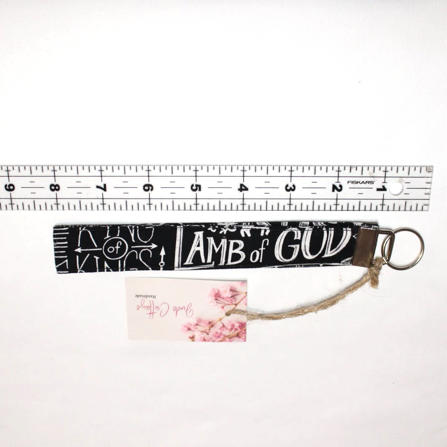 Close-up view of the King of Kings Wristlet shown below a ruler to demonstrate size.
