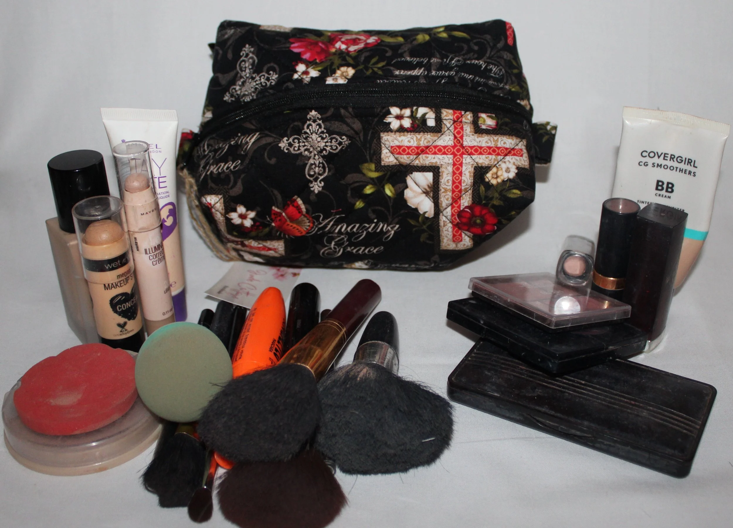 Top‑angle view of the small Amazing Grace quilted pouch in multicolor floral and cross print.