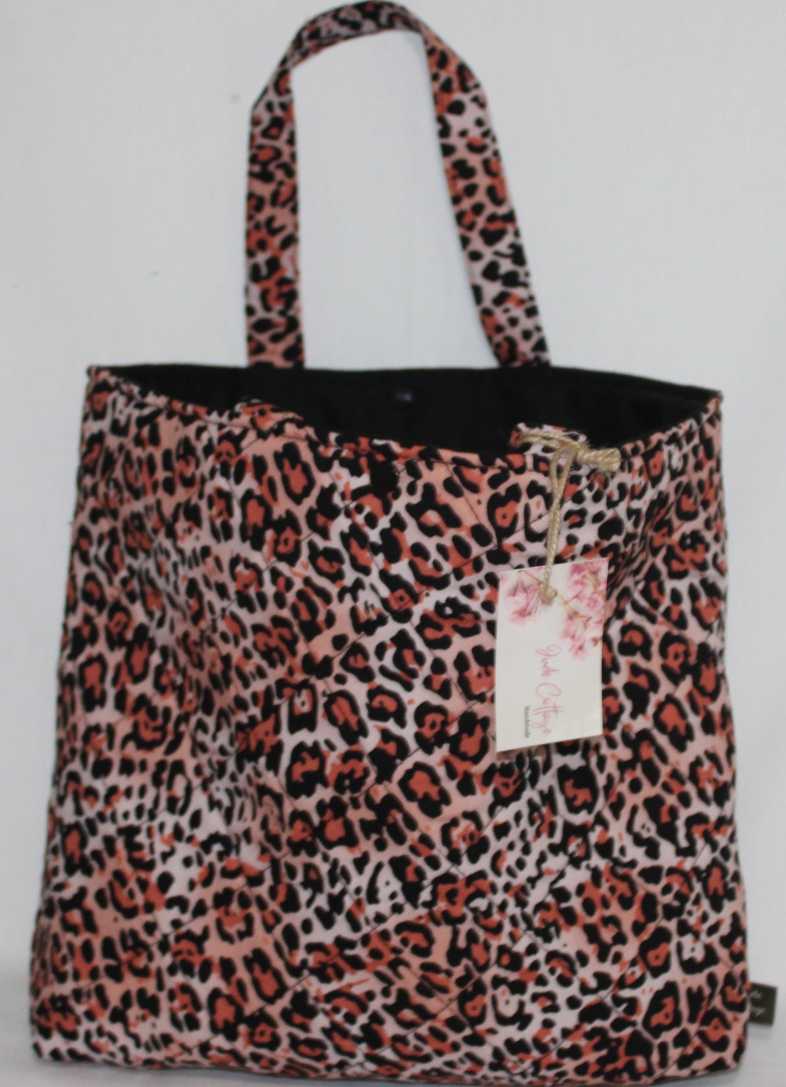 Front view of the Mia quilted Bible sleeve with pink cheetah‑print fabric and two carry handles.