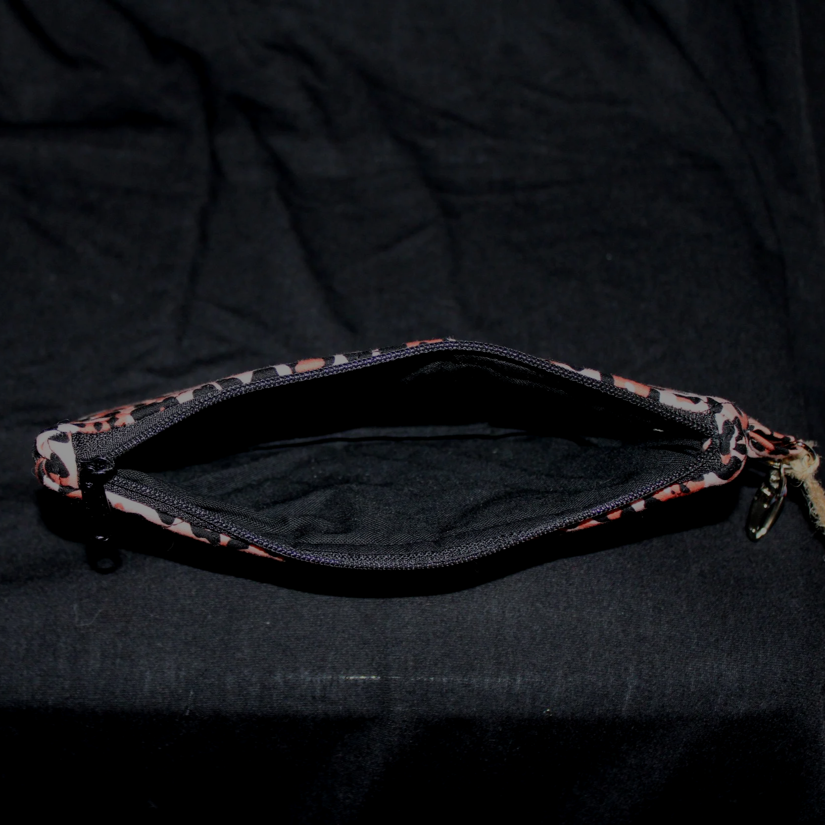 Top open view of the Mia Large Keychain Wallet showing the black zip closure and lining.