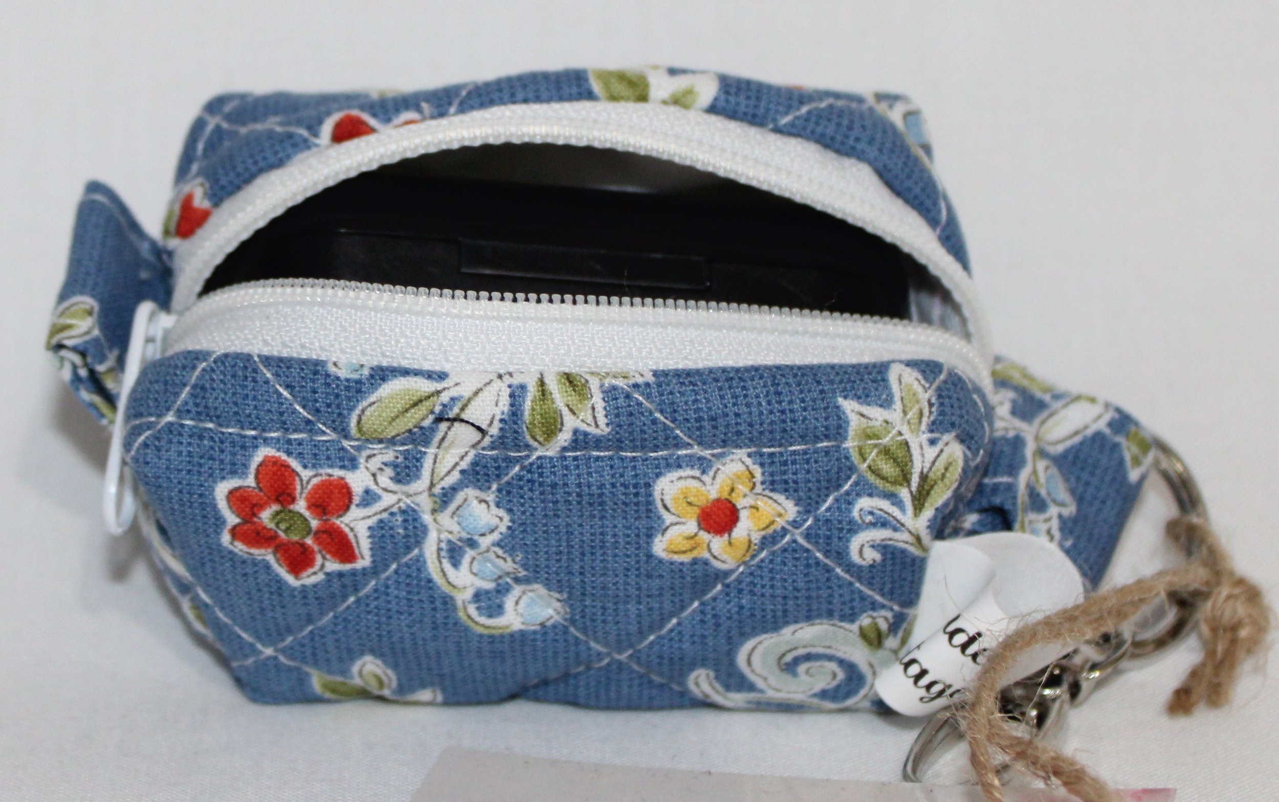 Open top view of the Liberty Blue Bag Charm with an Airpod Pro earbud case inserted to show fit.