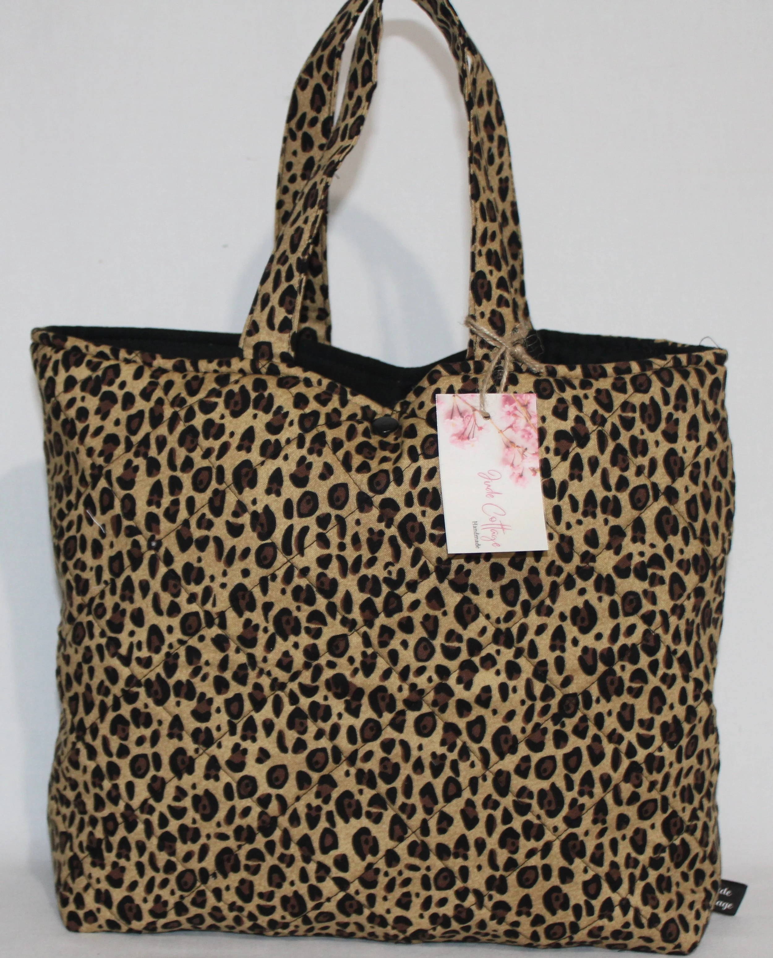 Front view of the Sahara quilted Bible sleeve with cheetah‑print fabric and two carry handles.