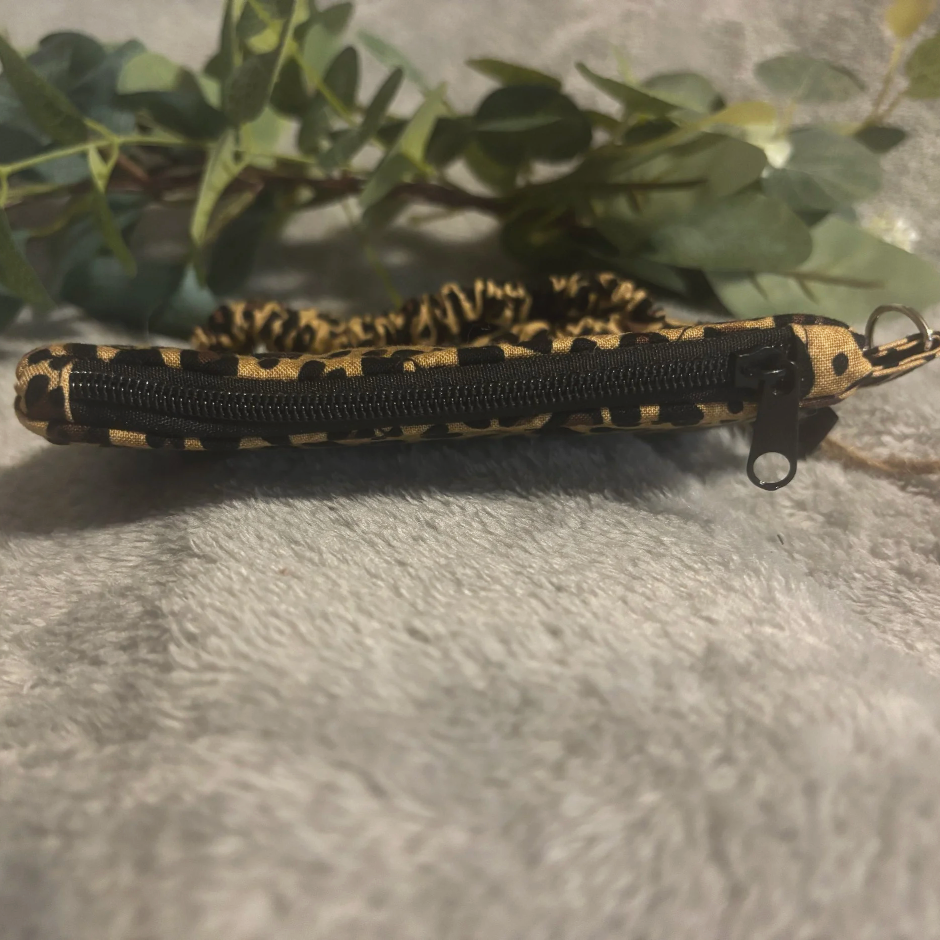 Top closed view of the Sahara keychain wallet showing zip closure.