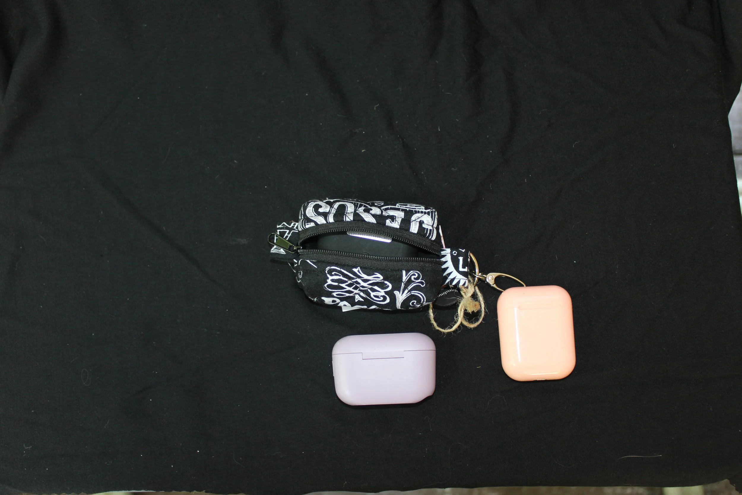 Top open view of the King of Kings Bag Charm with an airpod pro case inserted to show fit.