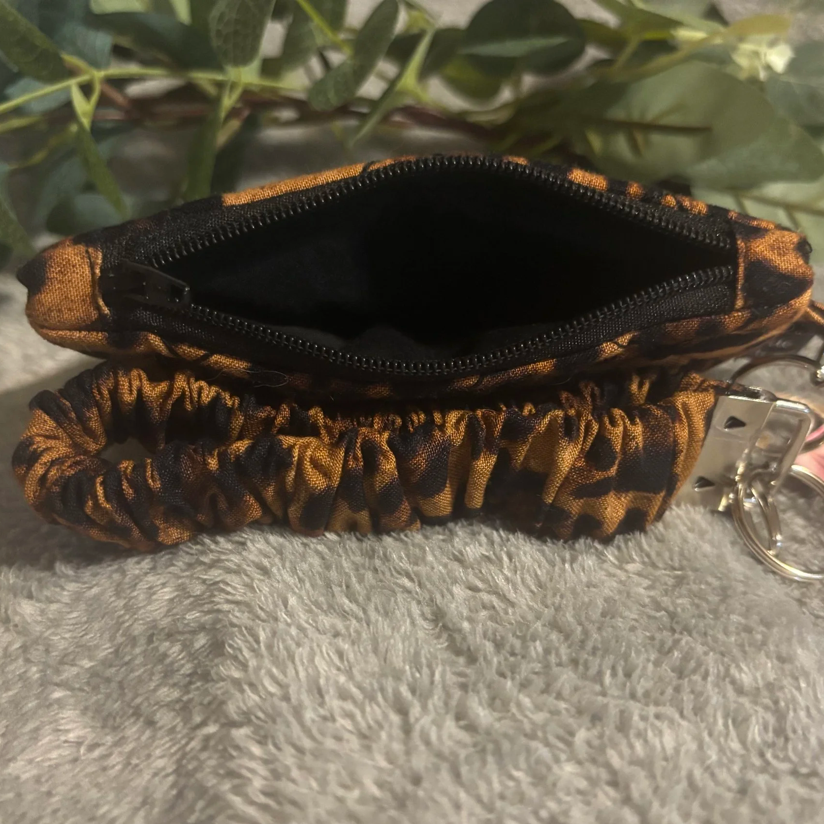 Top open view of the Lyra Keychain Wallet Set featuring a leopard print fabric and black interior lining.
