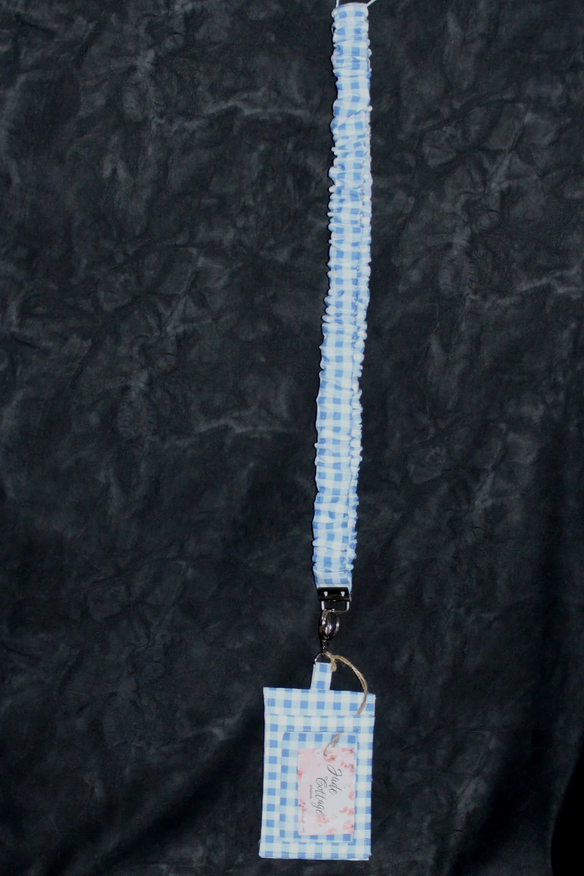 Full hanging view of the Annabeth Scrunch Lanyard with Badge Holder featuring a blue and white gingham print.