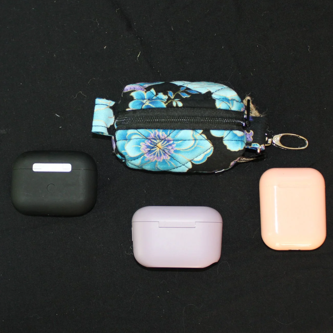 Top closed view of the zippered Twilight Paisley Bag Charm shown with J Lab  and air pod earbud cases for sizing reference.