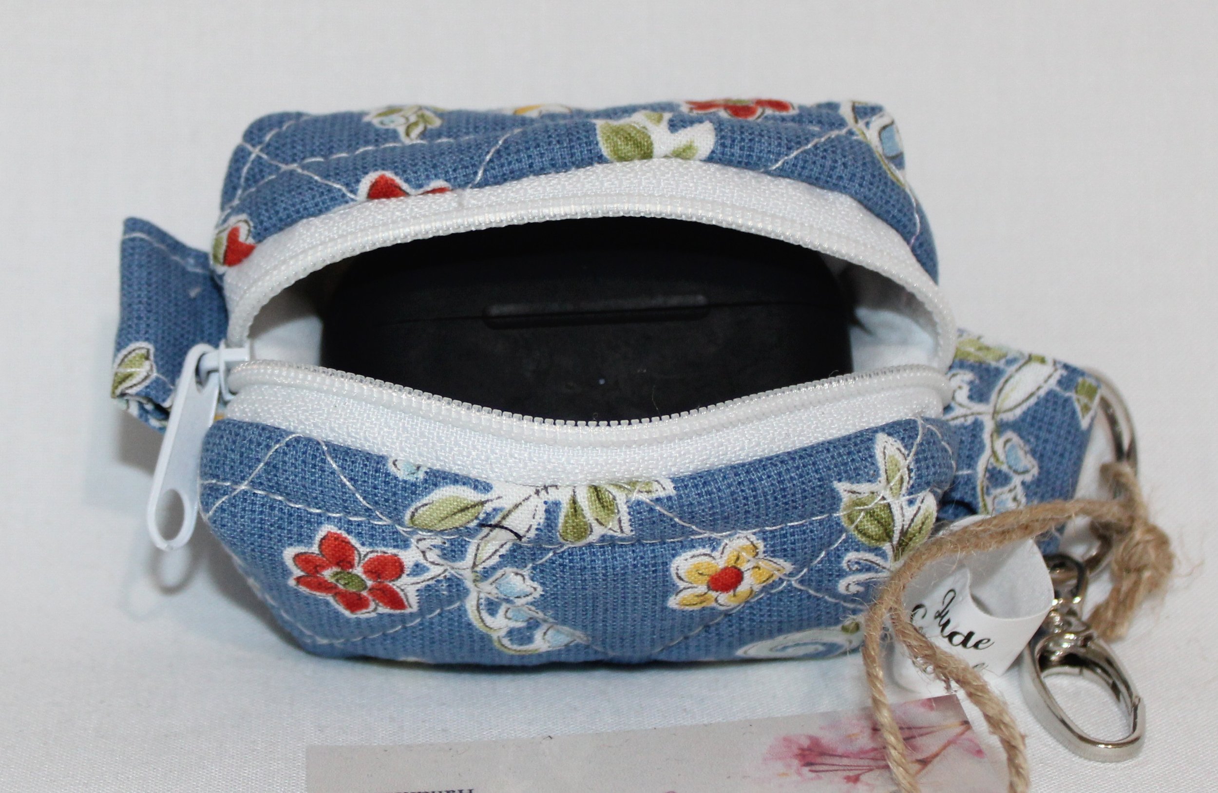 Open top view of the Liberty Blue Bag Charm with a J Lab earbud case inserted to show fit.