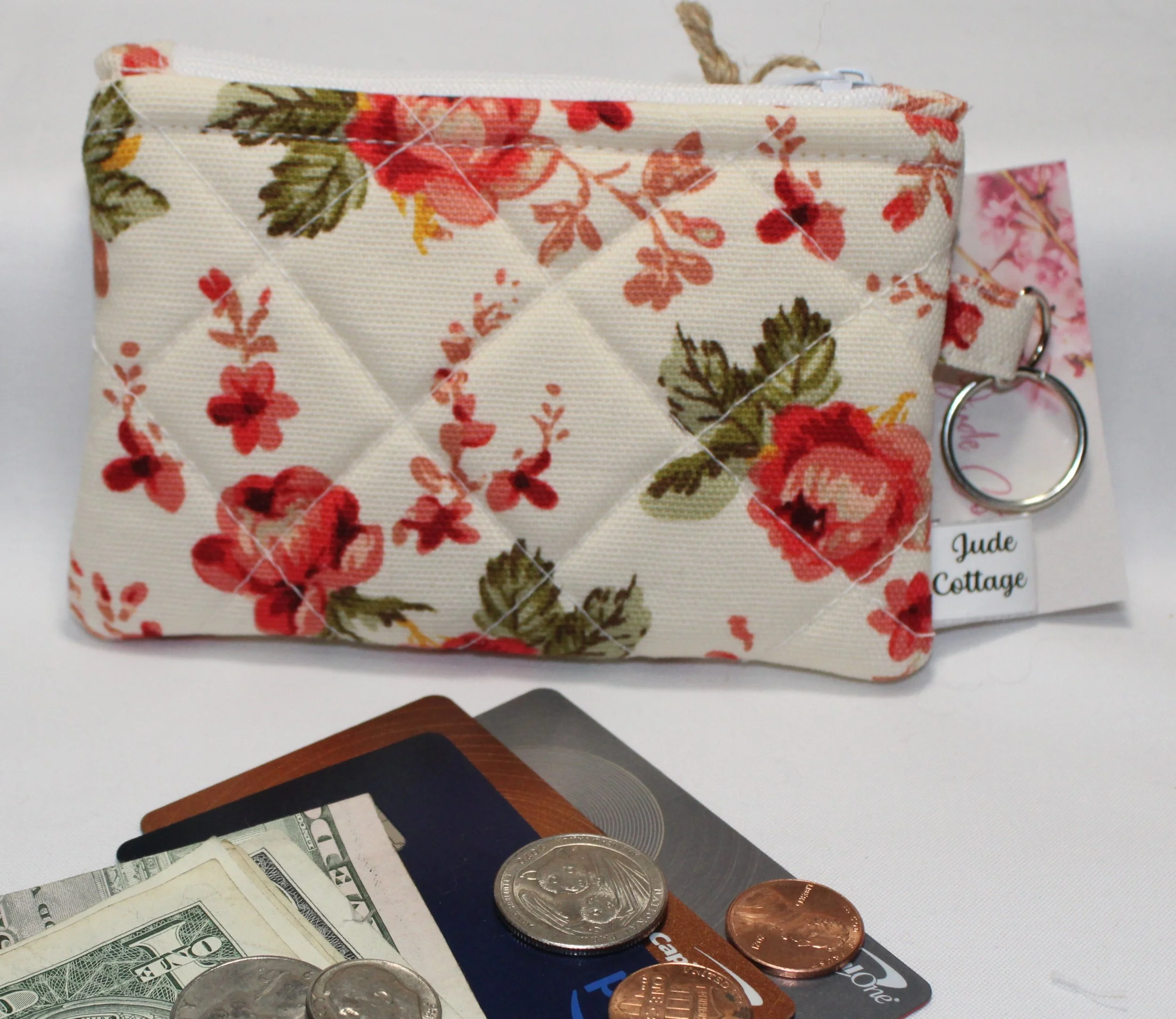 Quilted keychain wallet with English rose floral pattern, zipper closure, and metal key ring.