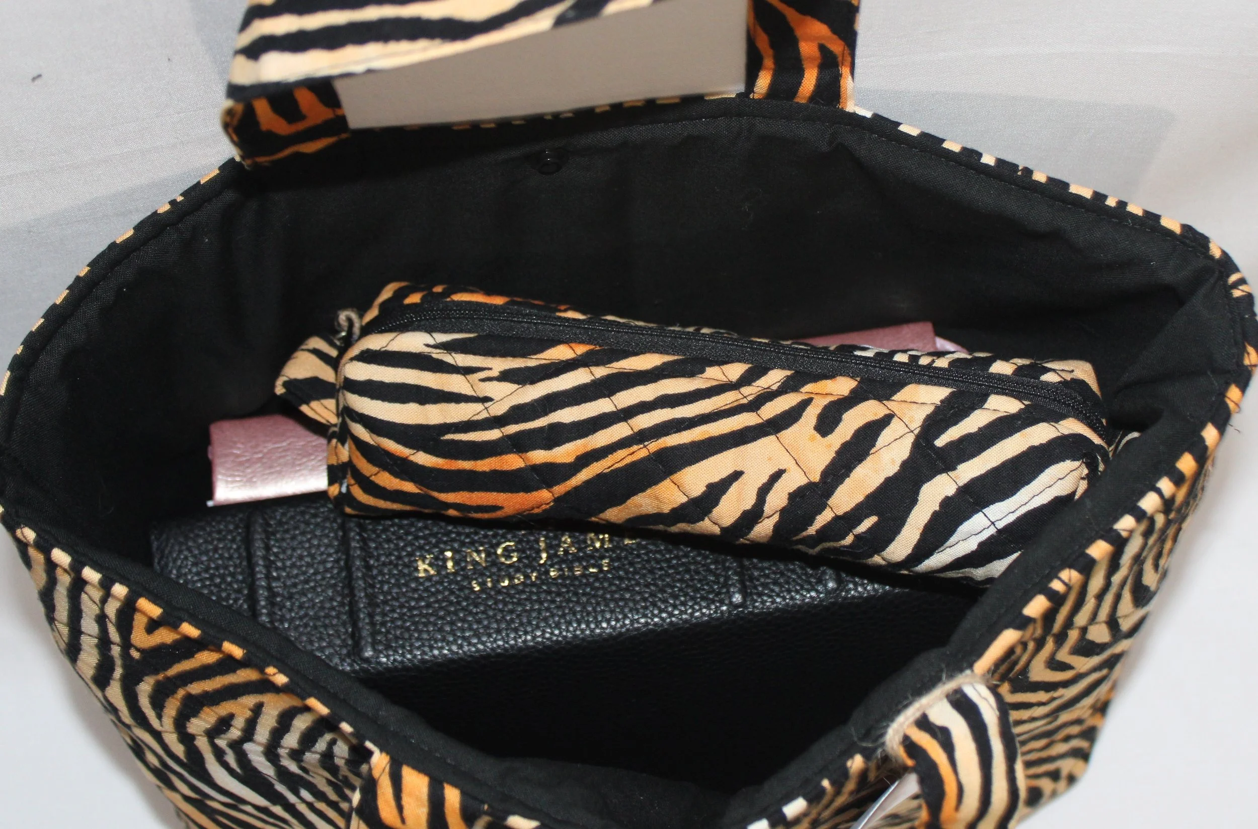 Top view of the Zara quilted Bible sleeve showing a study Bible, notebook and pencil case inserted to illustrate size and use.