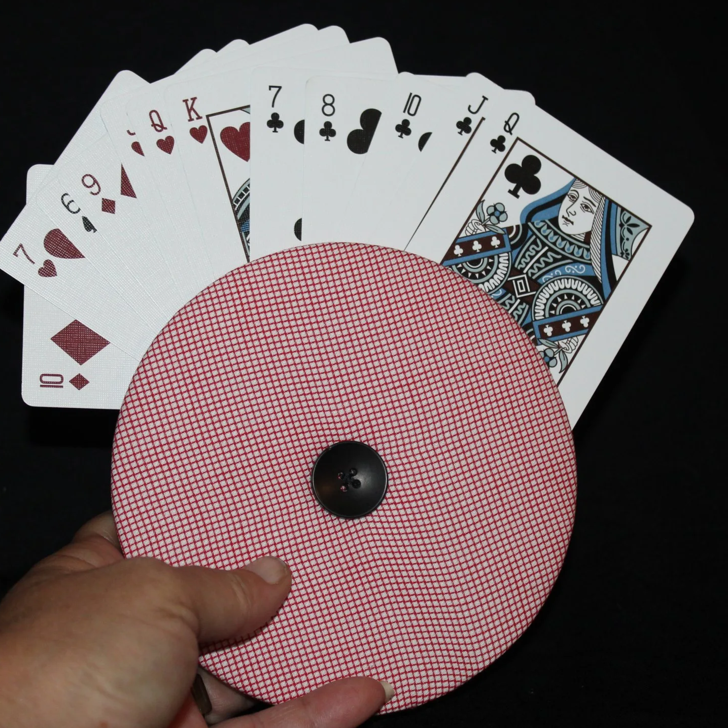 Front view of the Red Check Card Holder in use shown with an array of playing cards and being held, featuring a mini red and white check.