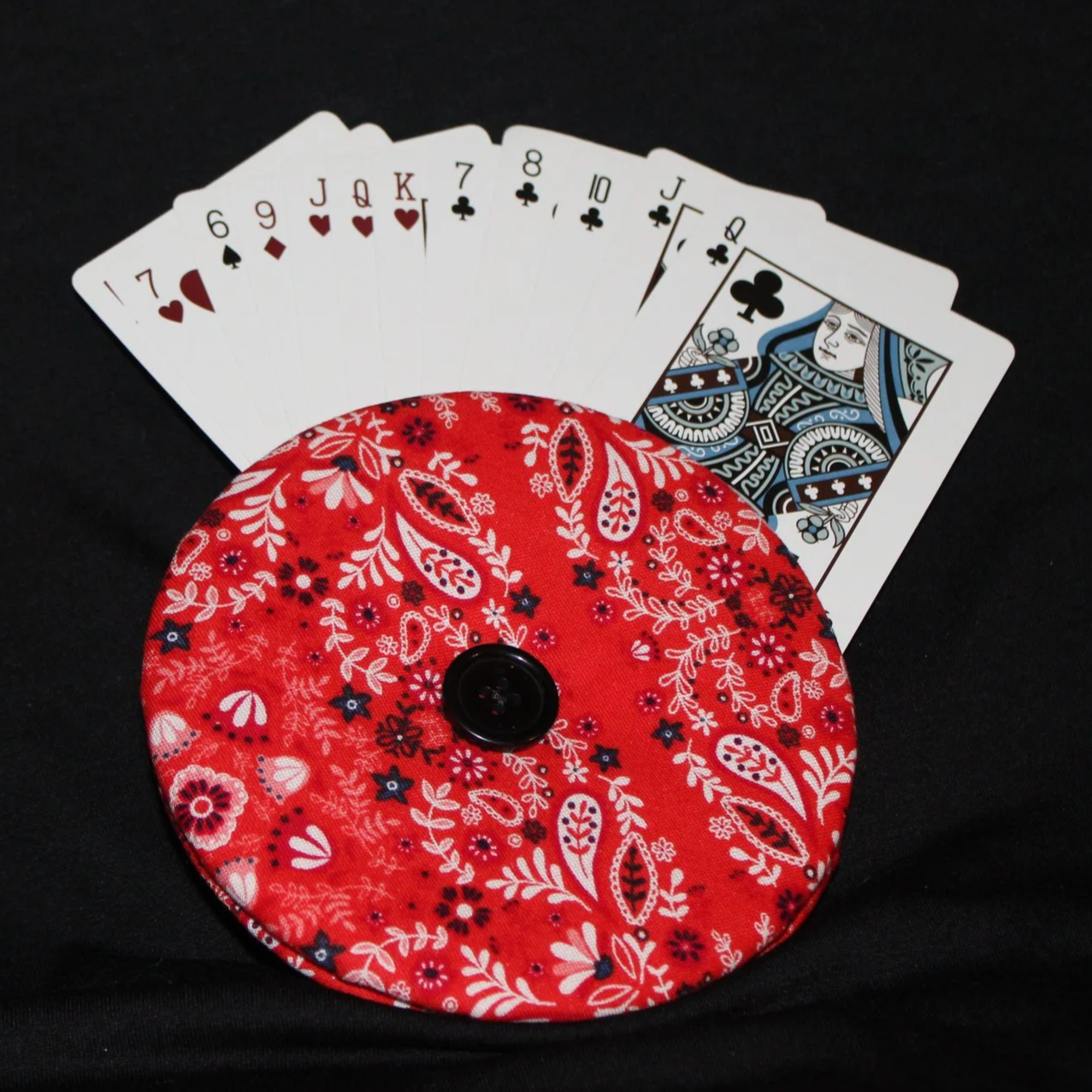 Front view of the Freedom Red Card Holder showing in use with an array of playing cards, featuring red, white, and navy paisley print fabric.