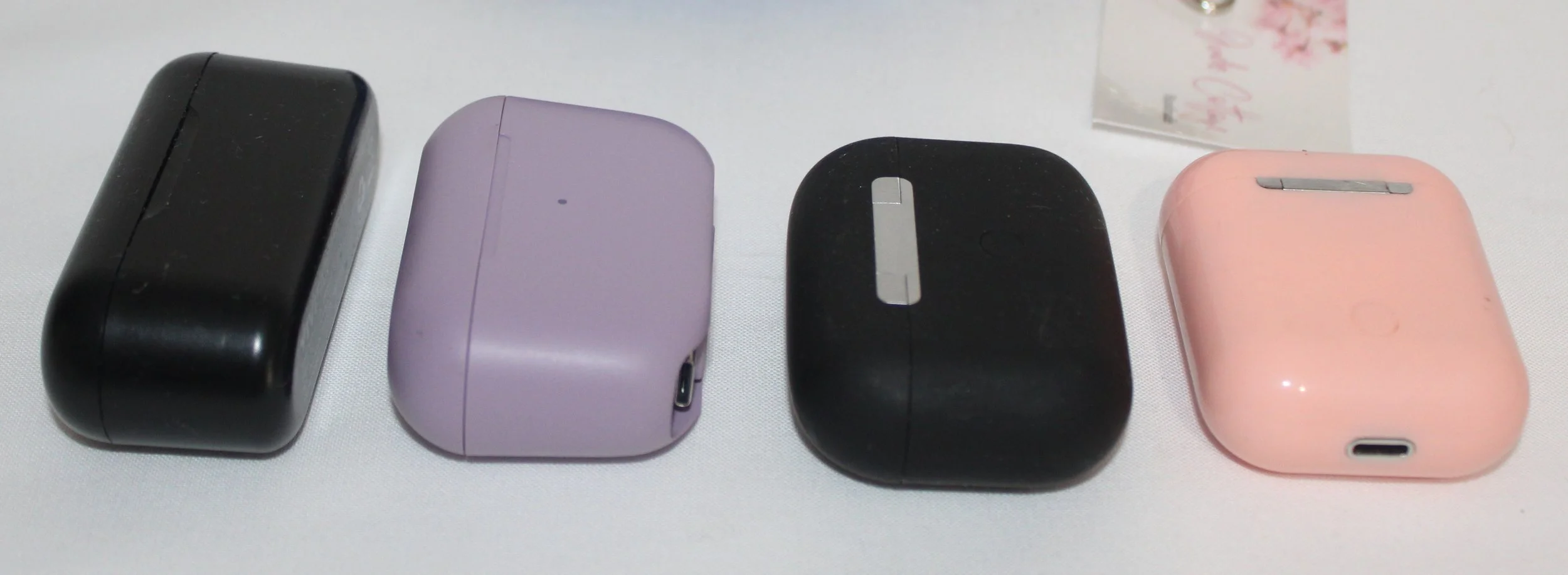 Photo of the different earbuds used for sizing: air pod, airpod pro, and J Lab.