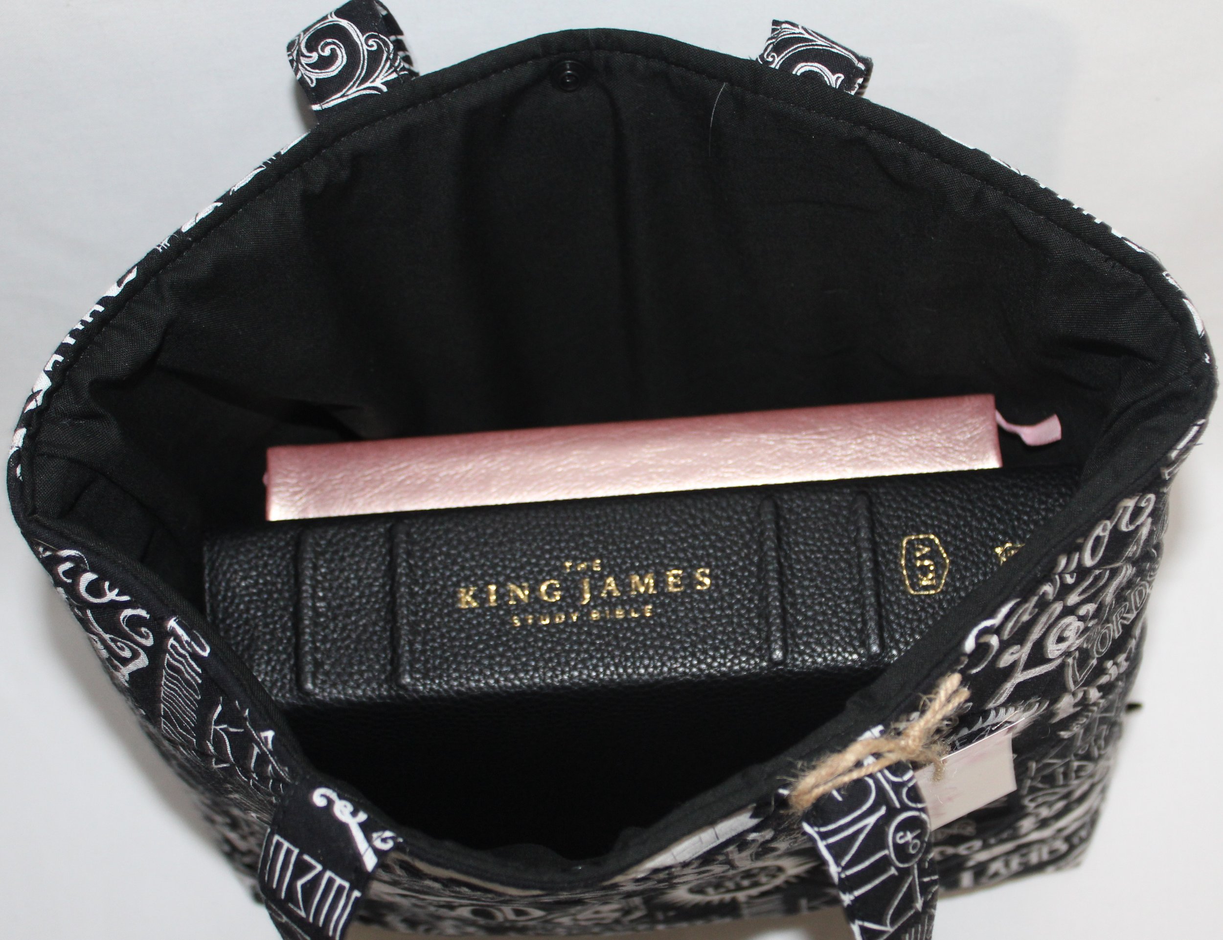 Top view of King of Kings quilted Bible sleeve shown with a study Bible and notebook inserted illustrating size and use.