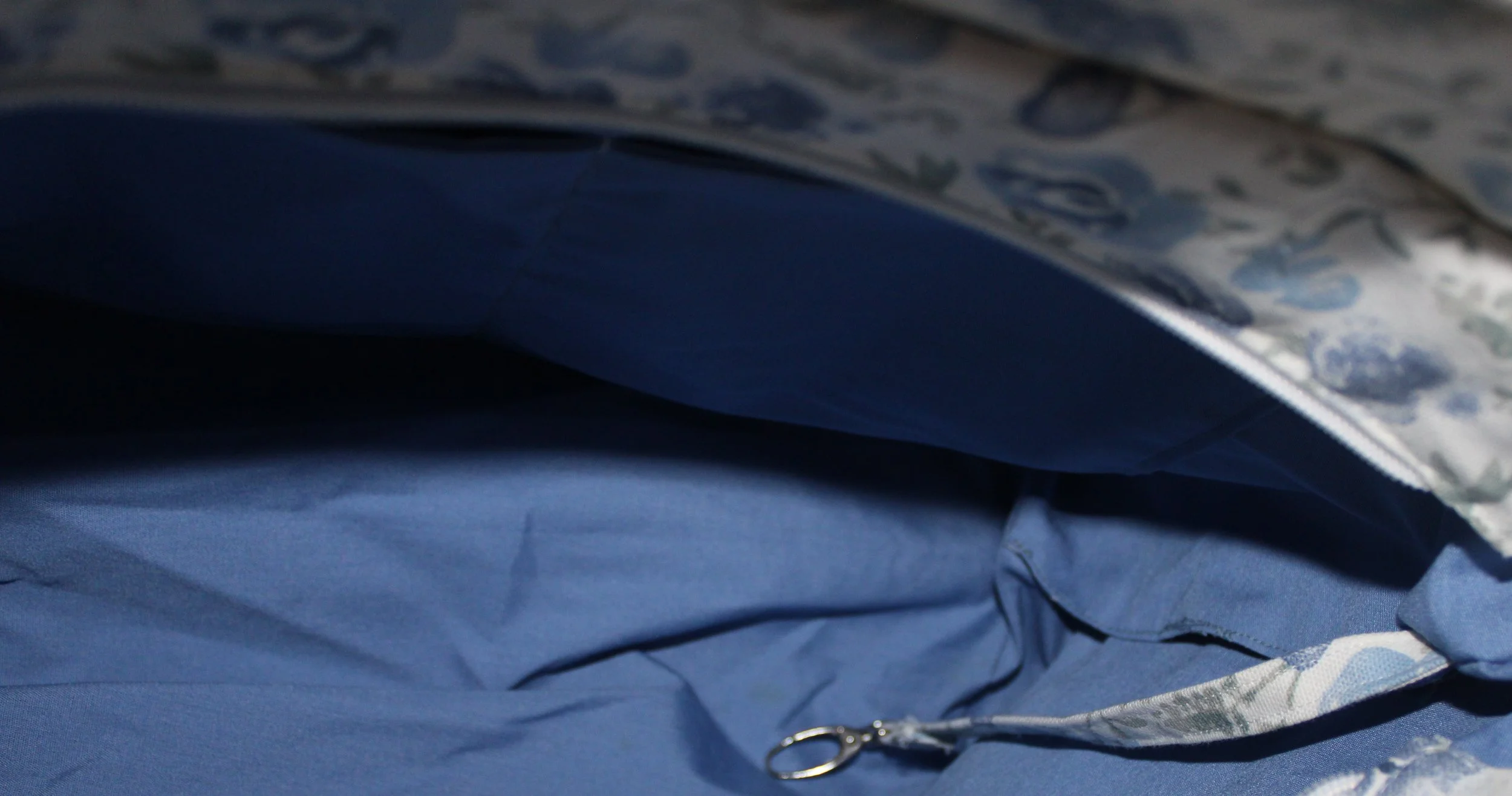 Interior view of the Elise quilted tote showing the two slip pockets, and attached key strap.