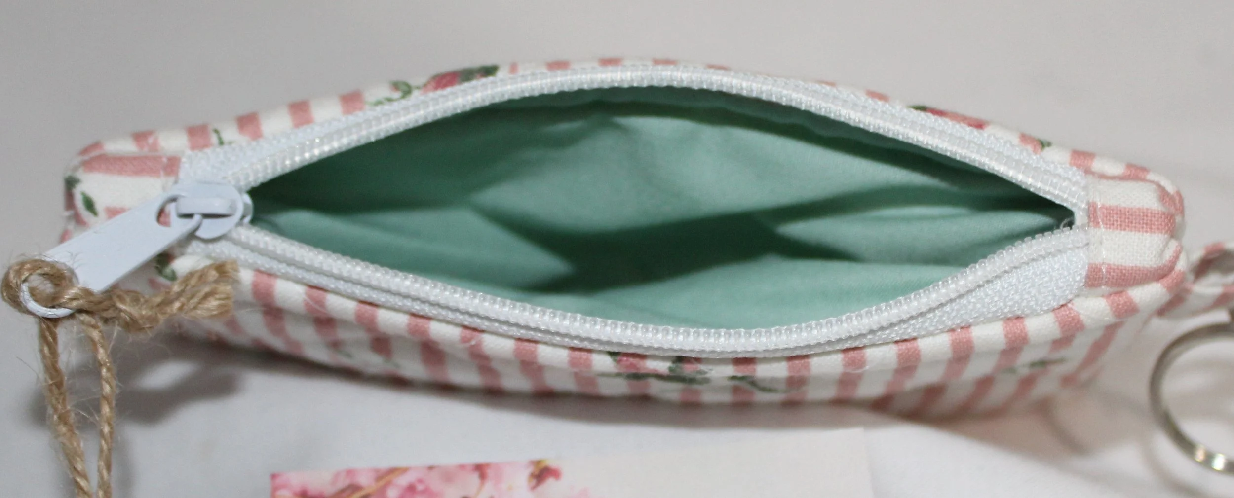 Top view quilted keychain wallet with Victorian floral pattern, zipper closure, and metal key ring.