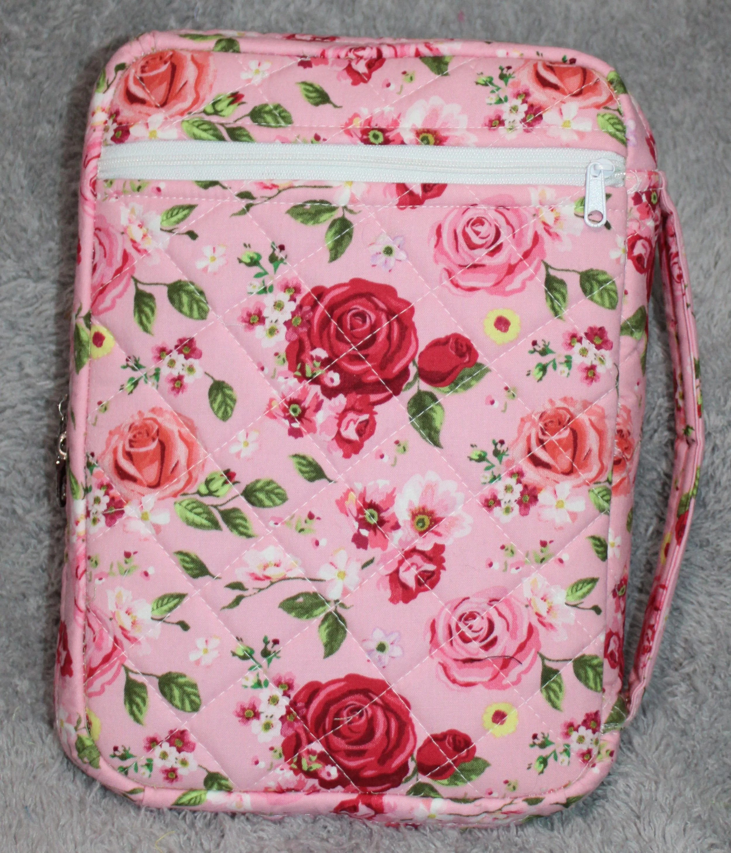 Back view of the Roselyn pink quilted double-zip Bible case showing the back zipper pocket and sturdy padded handle.