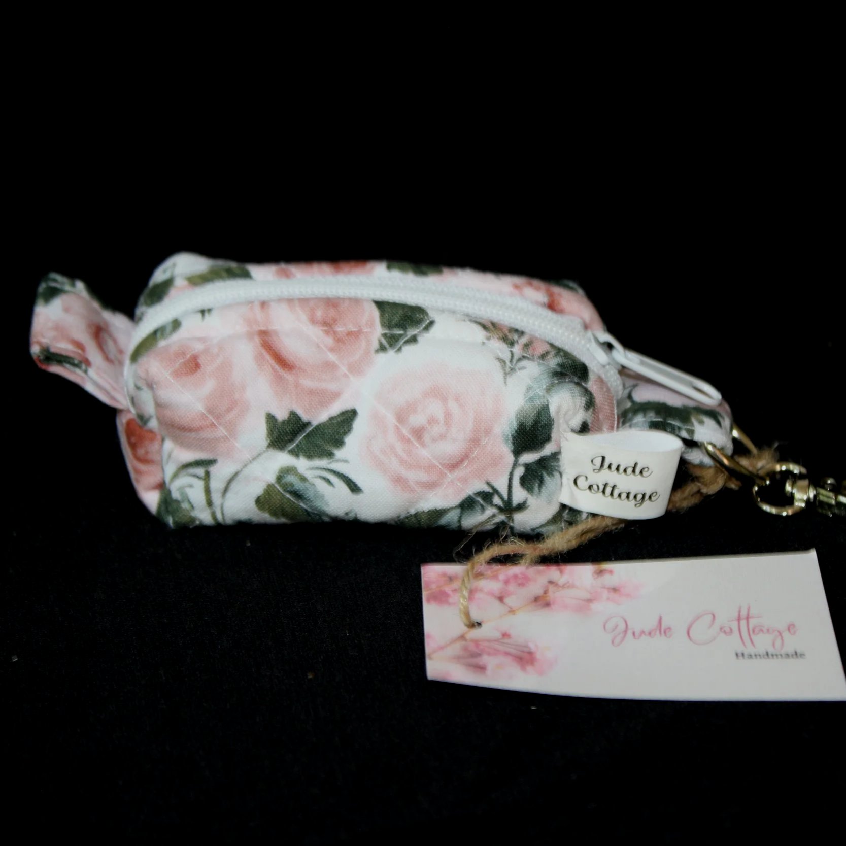 Front view of the Rose Garden Bag Charm featuring white fabric with pink rose print.