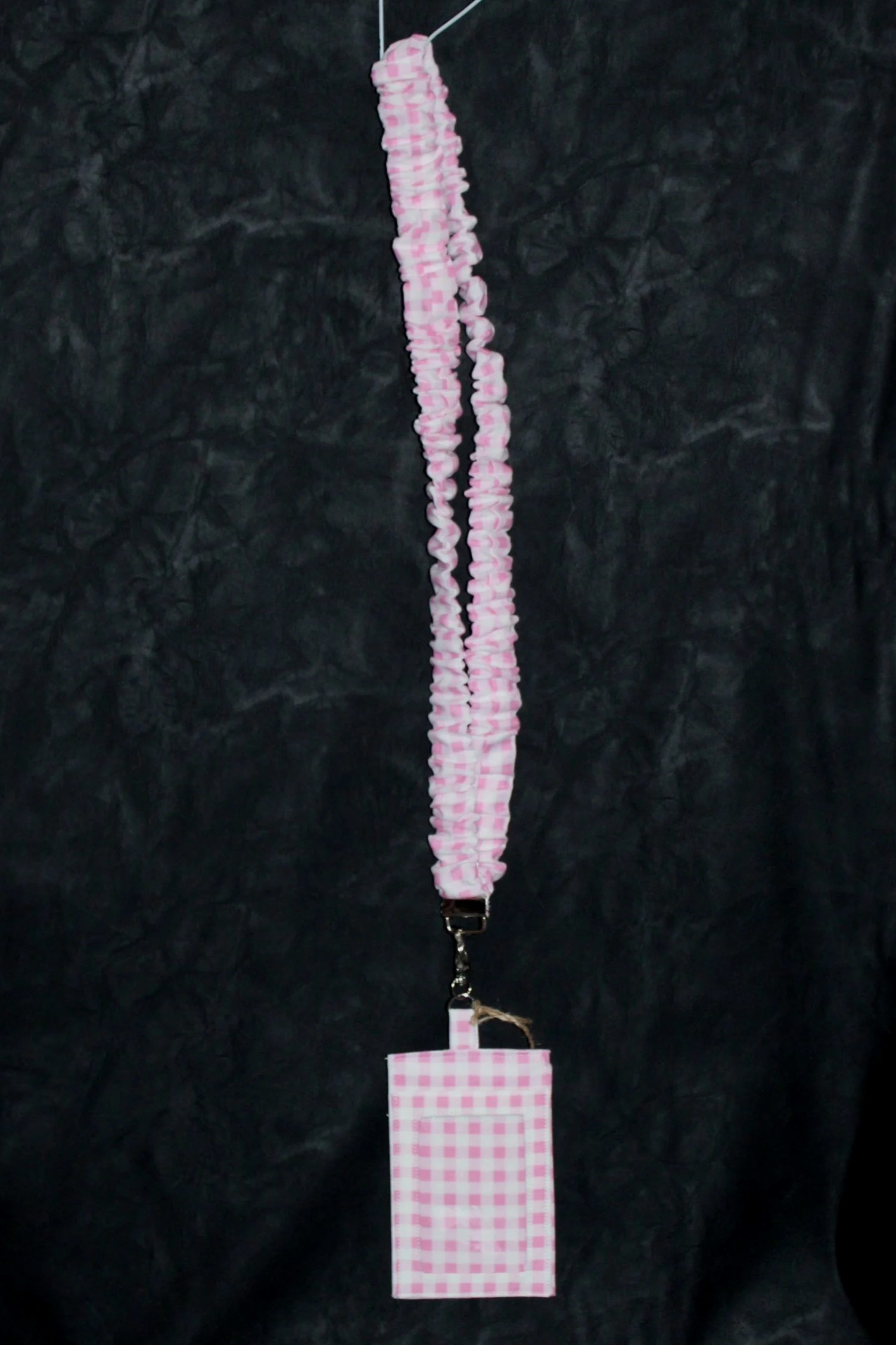 Full hanging view of the Annabelle Scrunch Lanyard with Badge Holder in featuring a pink and white gingham pattern.
