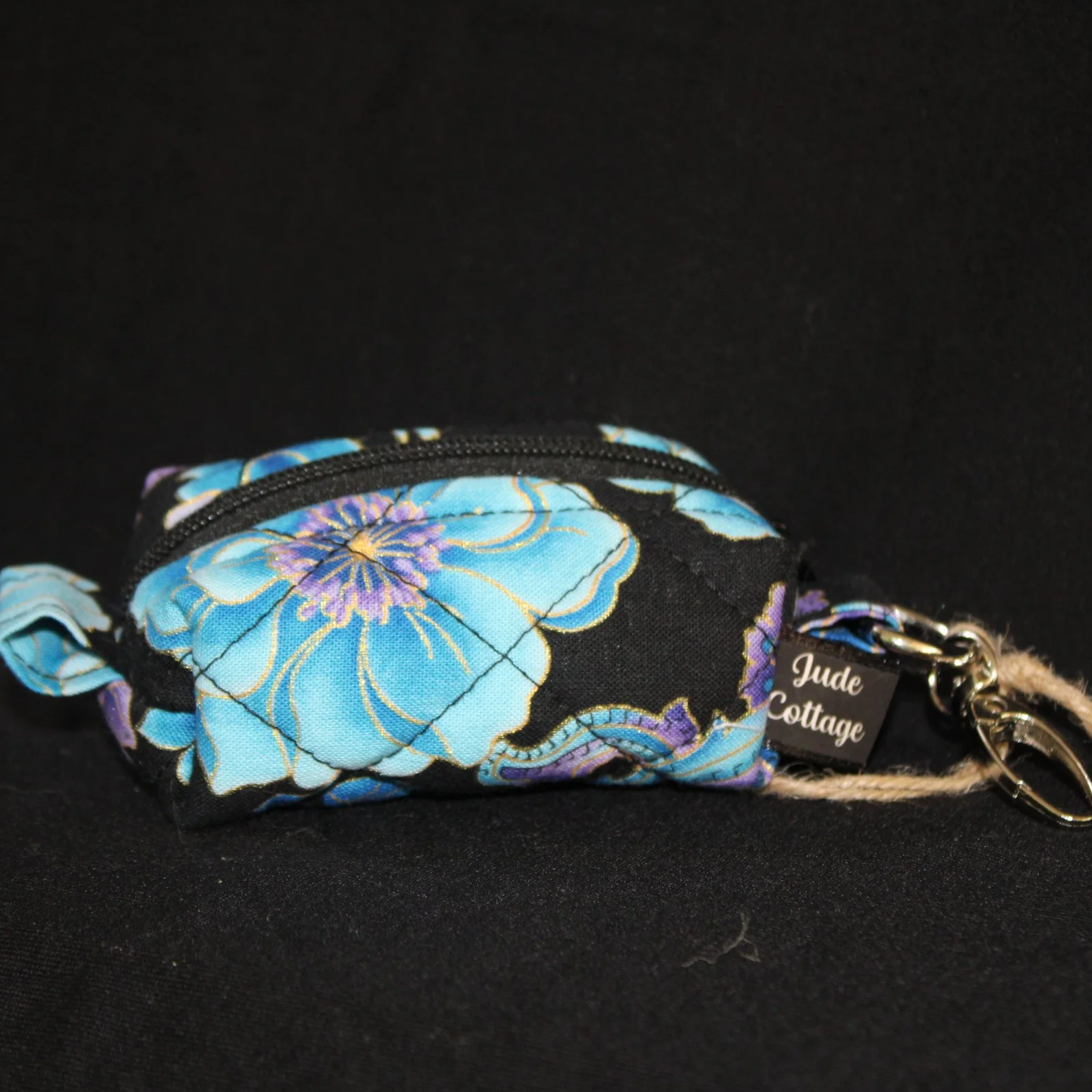 Up Close front view of the Twilight Paisley featuring teal and purple flowers with metallic accents on a black background.