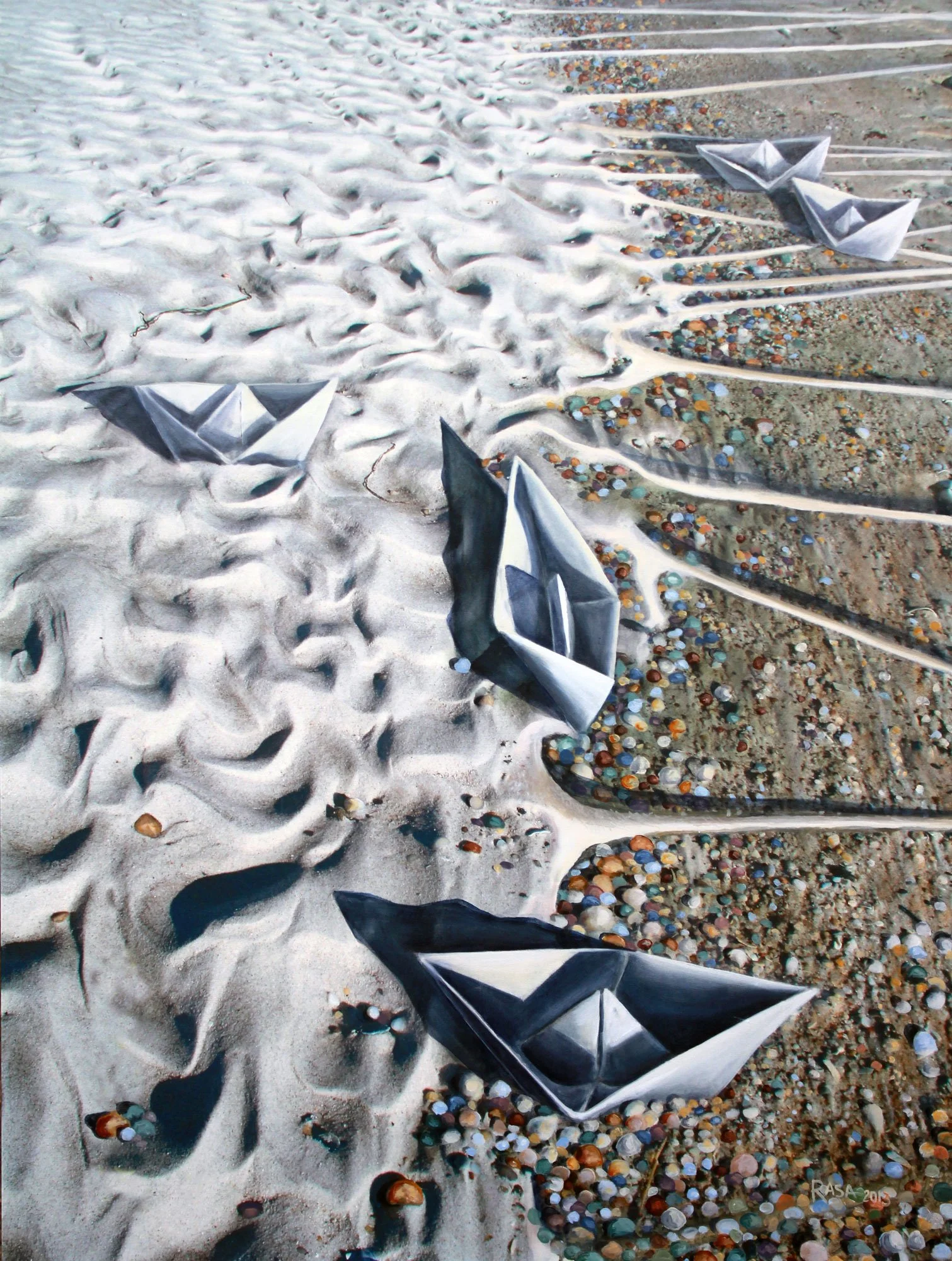 Three paper boats on sand, with some surrounded by colorful pebbles and others in foam-shaped formations.