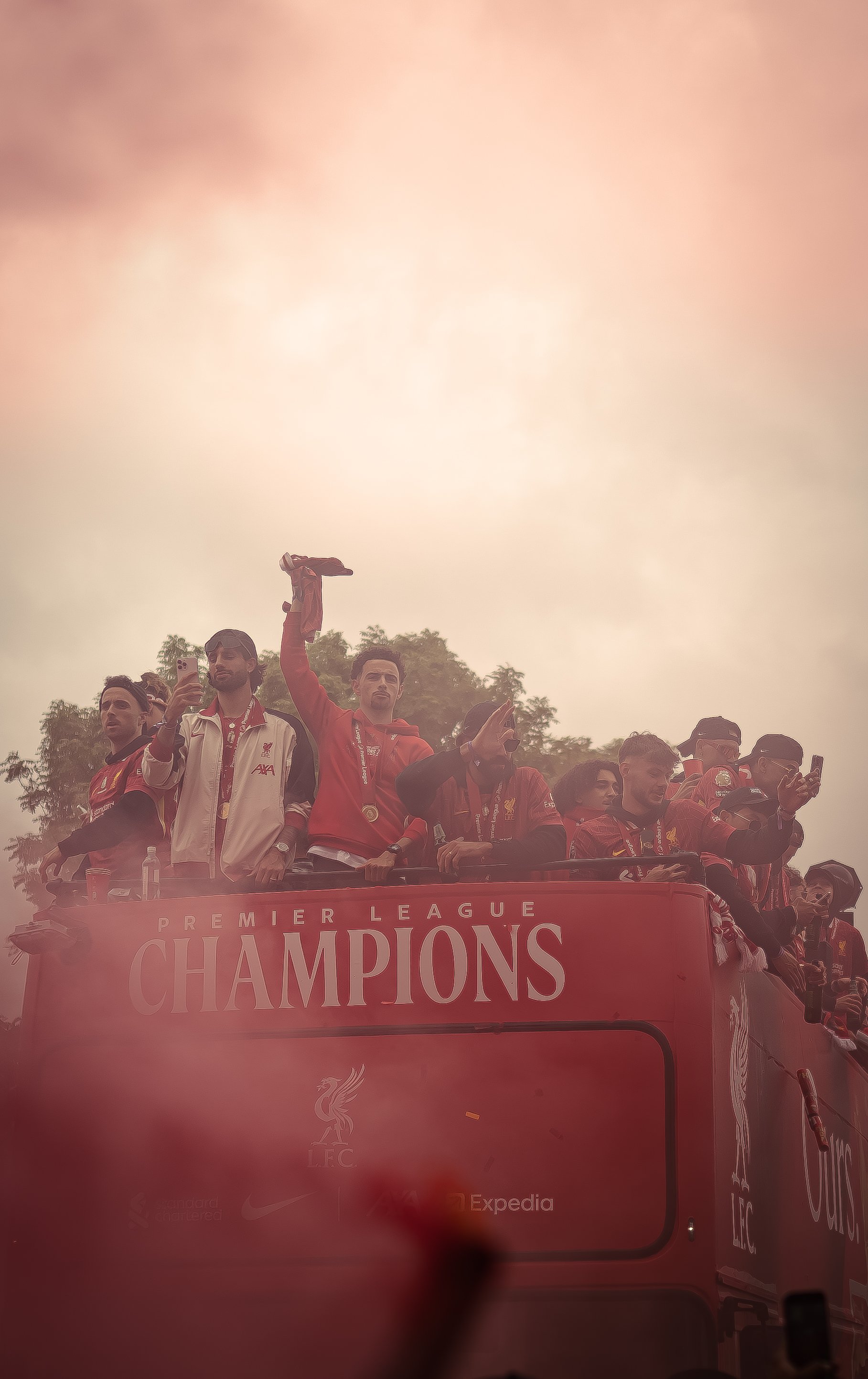 Liverpool football team celebrating as Premier League champions on a parade float.