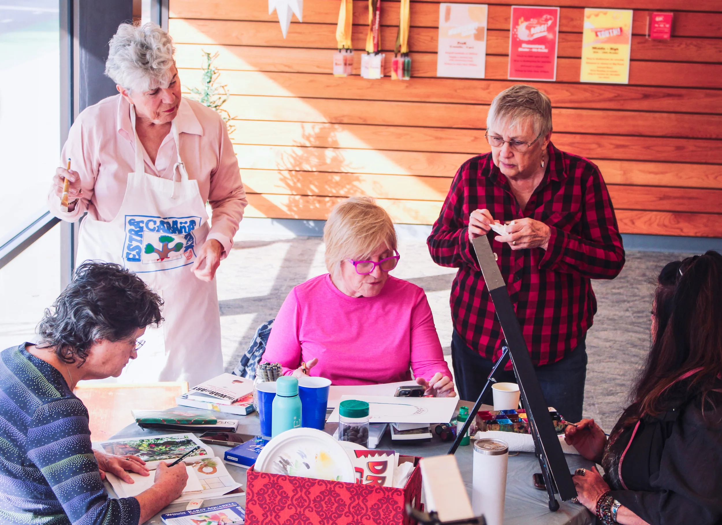 picture of five women working on art together