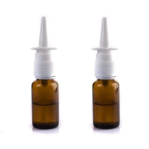 Two small amber glass bottles with nasal spray nozzles.