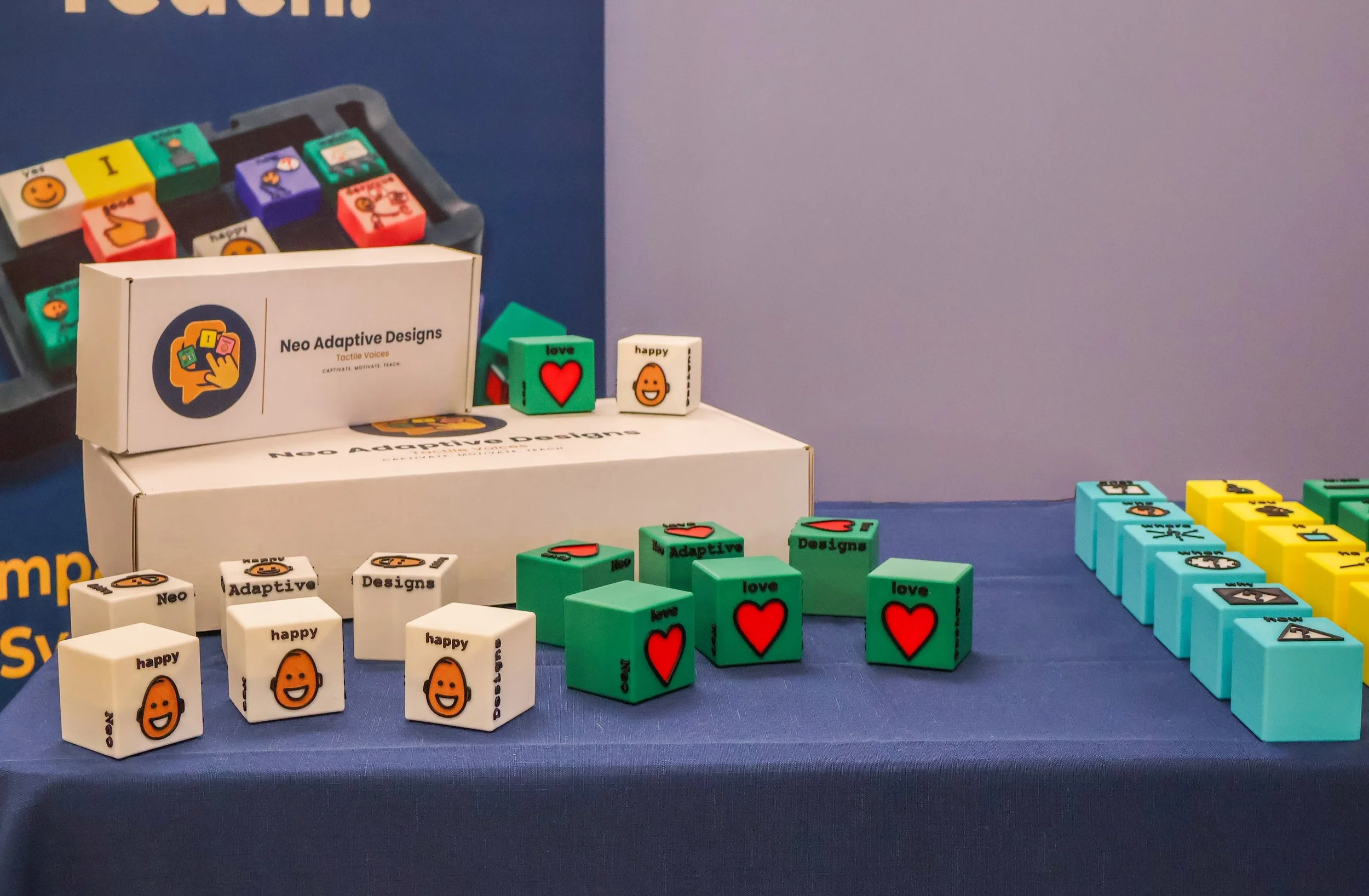 Tactile Voices booth at CSHA 2026 with colorful tactile AAC blocks displayed on a blue table