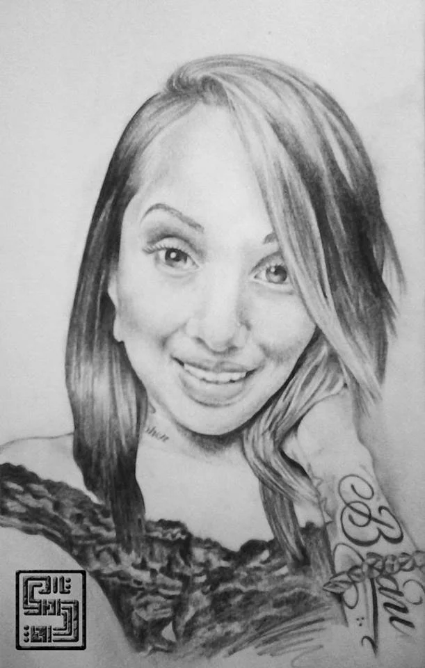 Black and white pencil drawing of a smiling woman with long hair and a tattoo on her shoulder.