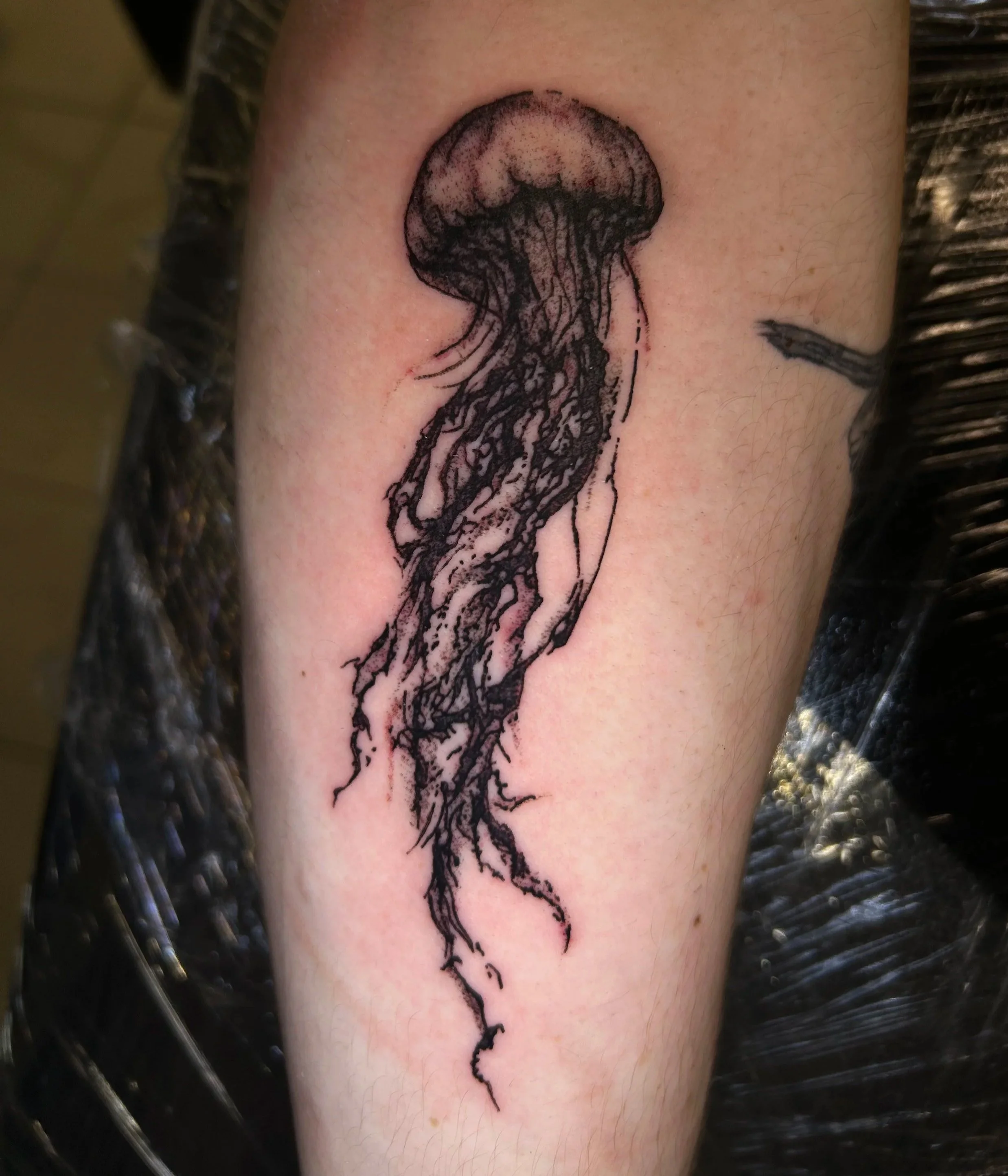 Tattoo of a black ink tree with roots on person's skin