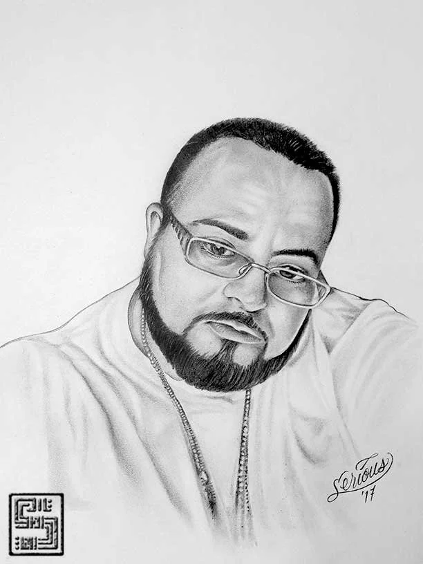 Black and white portrait drawing of a man with glasses, a beard, and a mustache, wearing a T-shirt and chains, looking at the camera with a serious expression.