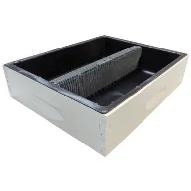 A rectangular black and white sterilizer or autoclave with a metal rack inside.