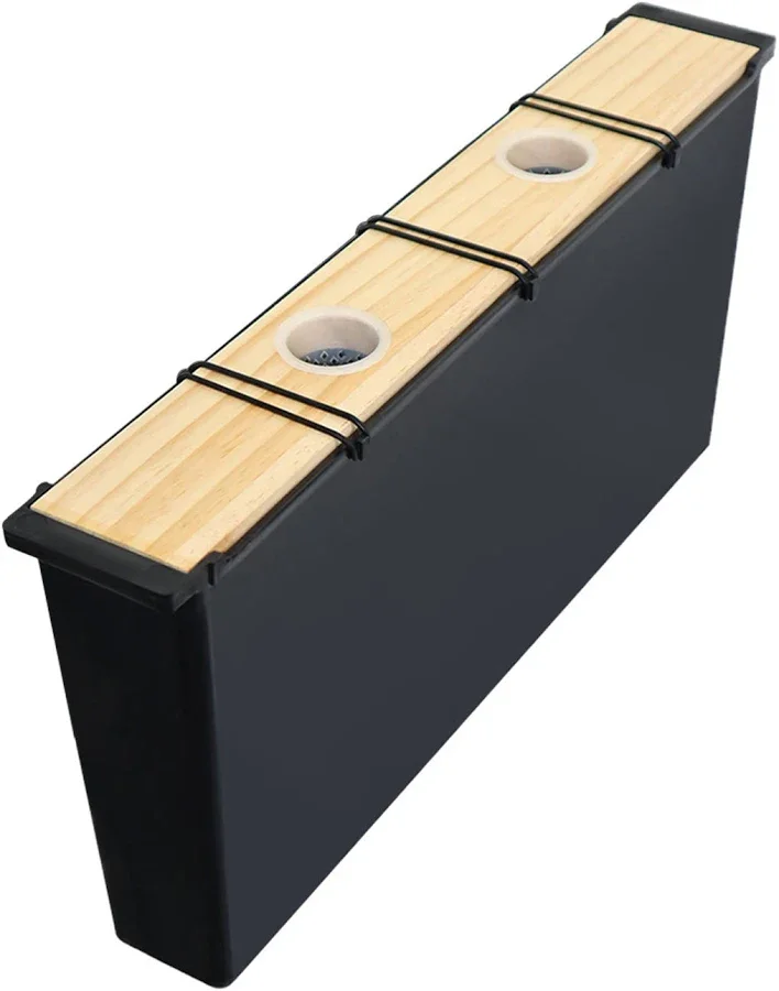 Black wooden beer pong table with two metal rings and a wooden top.