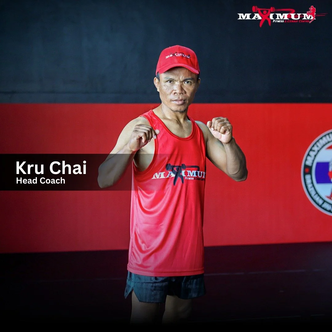 A man in a red sports tank top and red cap standing with fists raised in a fighting stance in front of a black and red background with gym logos. The text overlay reads 'Kru Chai, Head Coach'.