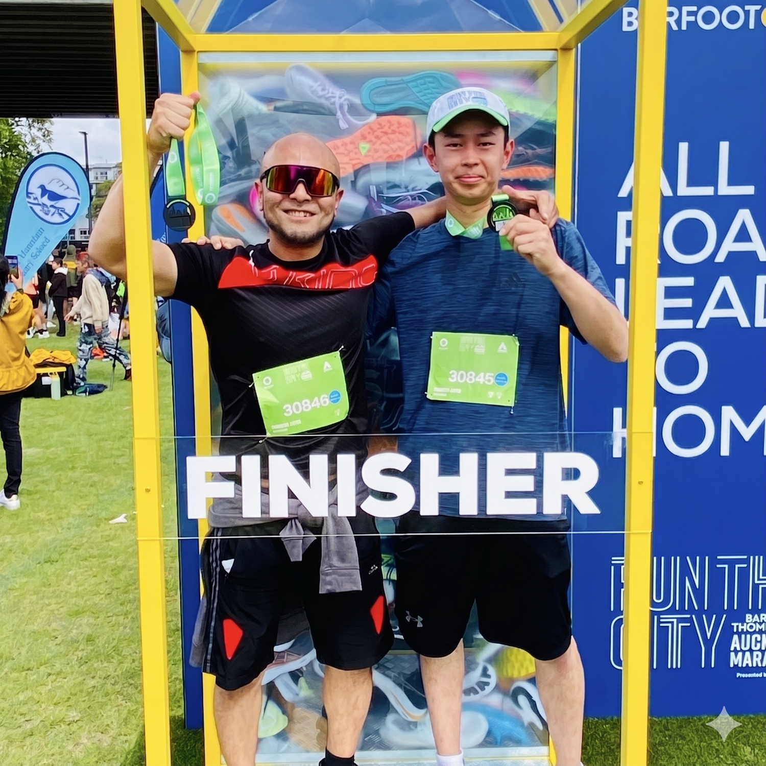 Ken Yonei and Shogo Shimizu with their arms around each other at the Auckland Marathon