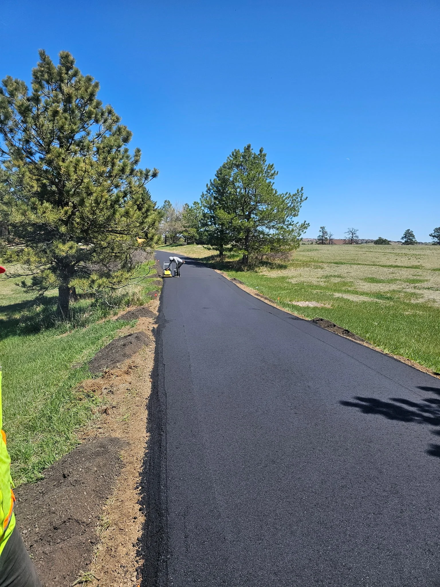 Newly paved asphalt road completed by HB Concrete & Asphalt in Castle Rock, Colorado.