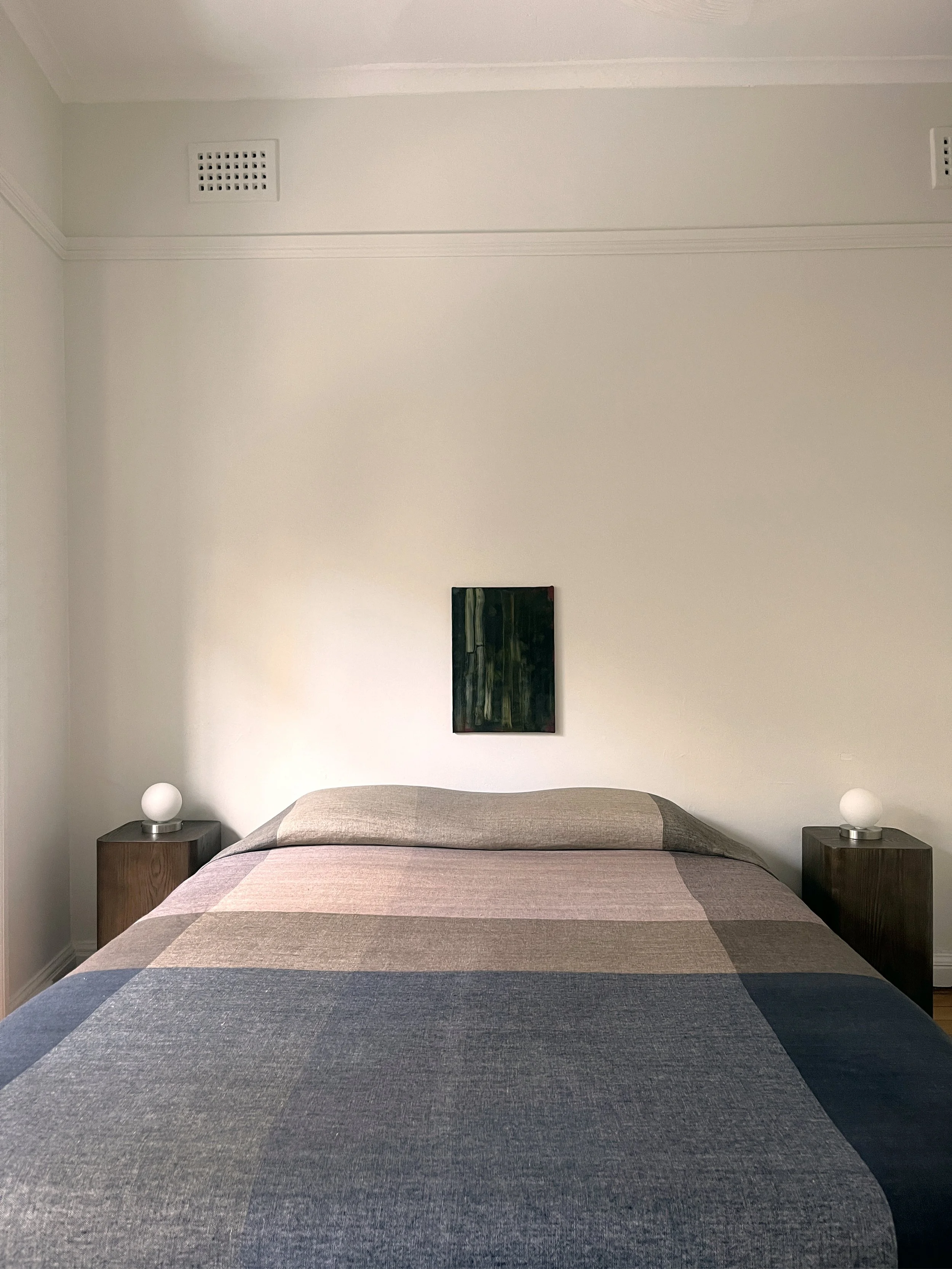 A balanced bedroom composition with clean lines, layered textiles, and sculptural lighting. A refined approach to modern interior design.