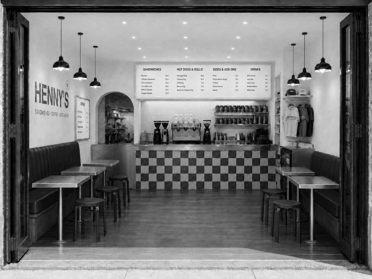 Interior of a small sandwich shop called Henny's Deli, with a counter, menu boards, seating, and hanging pendant lights in a modern style.