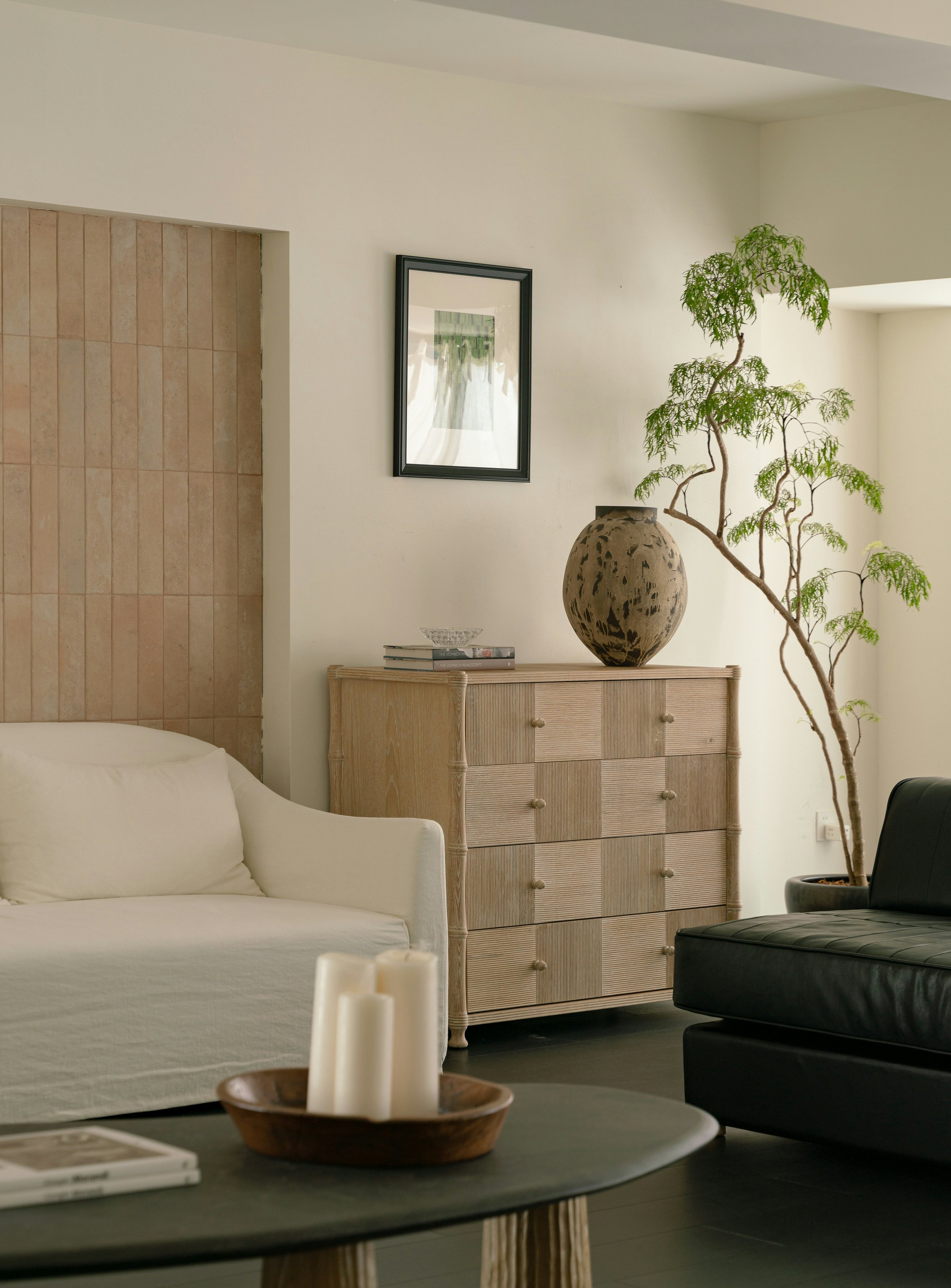 Warm minimalist living room with timber cabinetry, neutral tones and curated styling by Carlo Paul Interiors Sydney