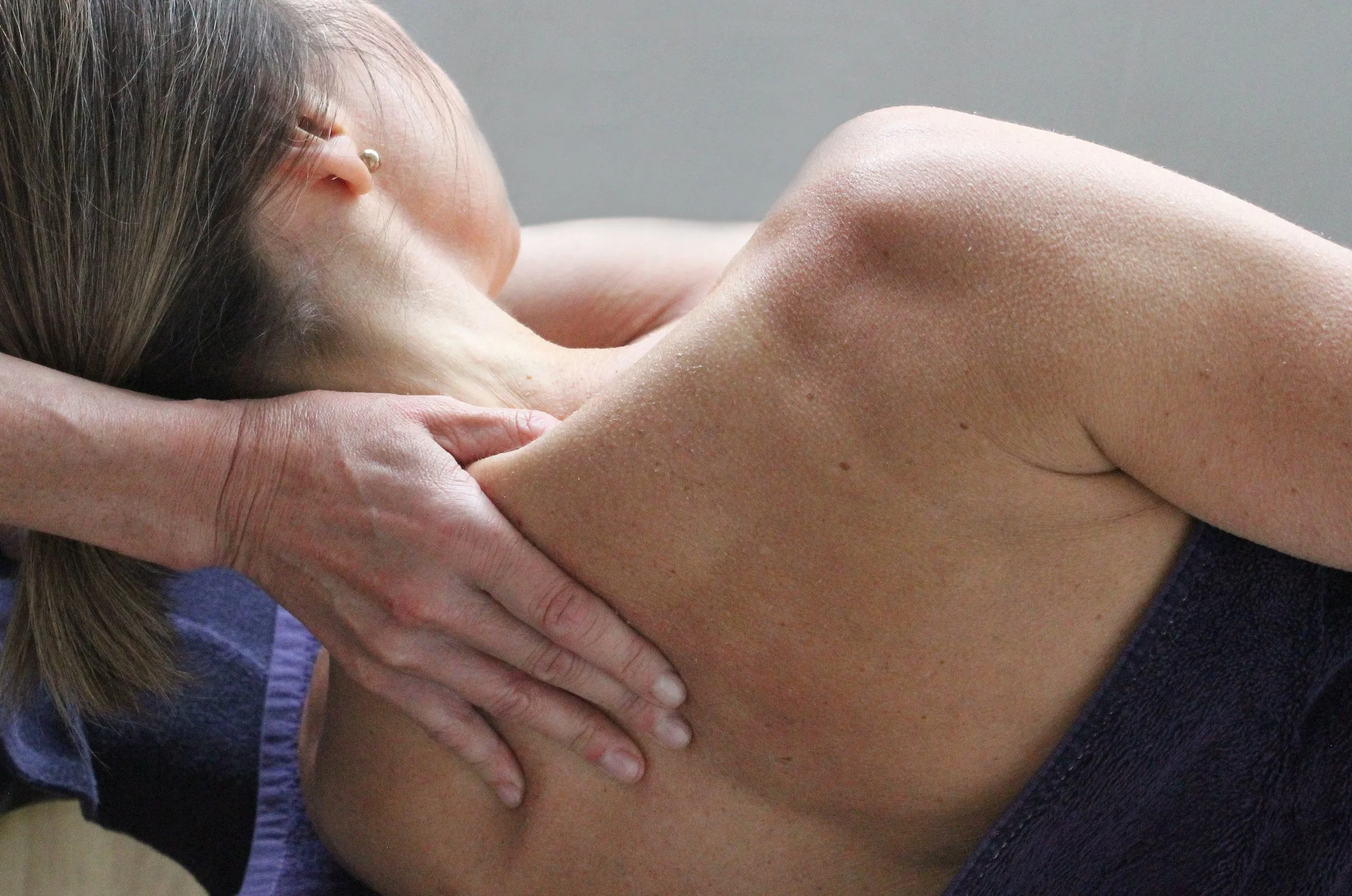 A person receiving a shoulder massage.