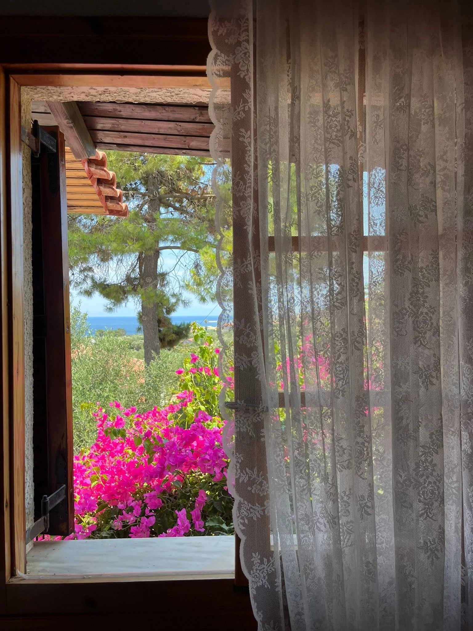 Holiday villa window with pink bougainvillea, Messinia Greece – Saint Friday Villas, traditional Greek countryside