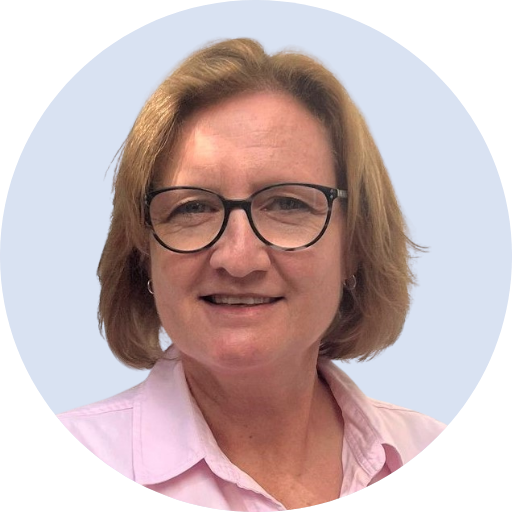 A woman with light brown hair, wearing glasses and a pink collared shirt, smiling at the camera.  Lisa Jooste, Registered Psychologist.