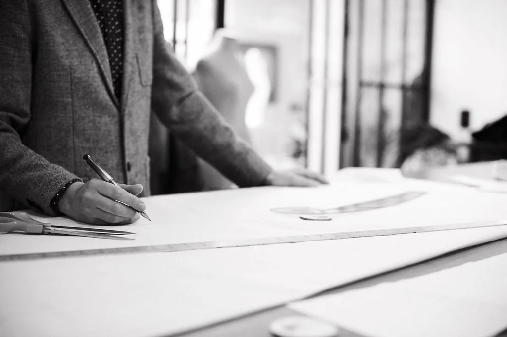 PETAR atelier design process, with a garment being sketched on paper