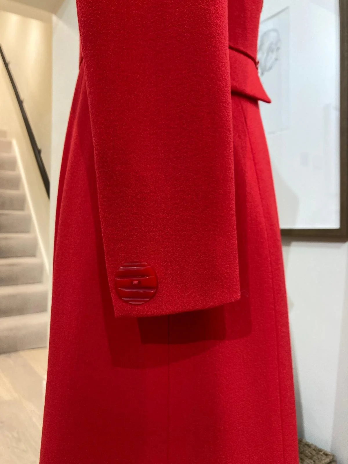Detail of the finished bespoke red coat dress with close up of sleeve by PETAR